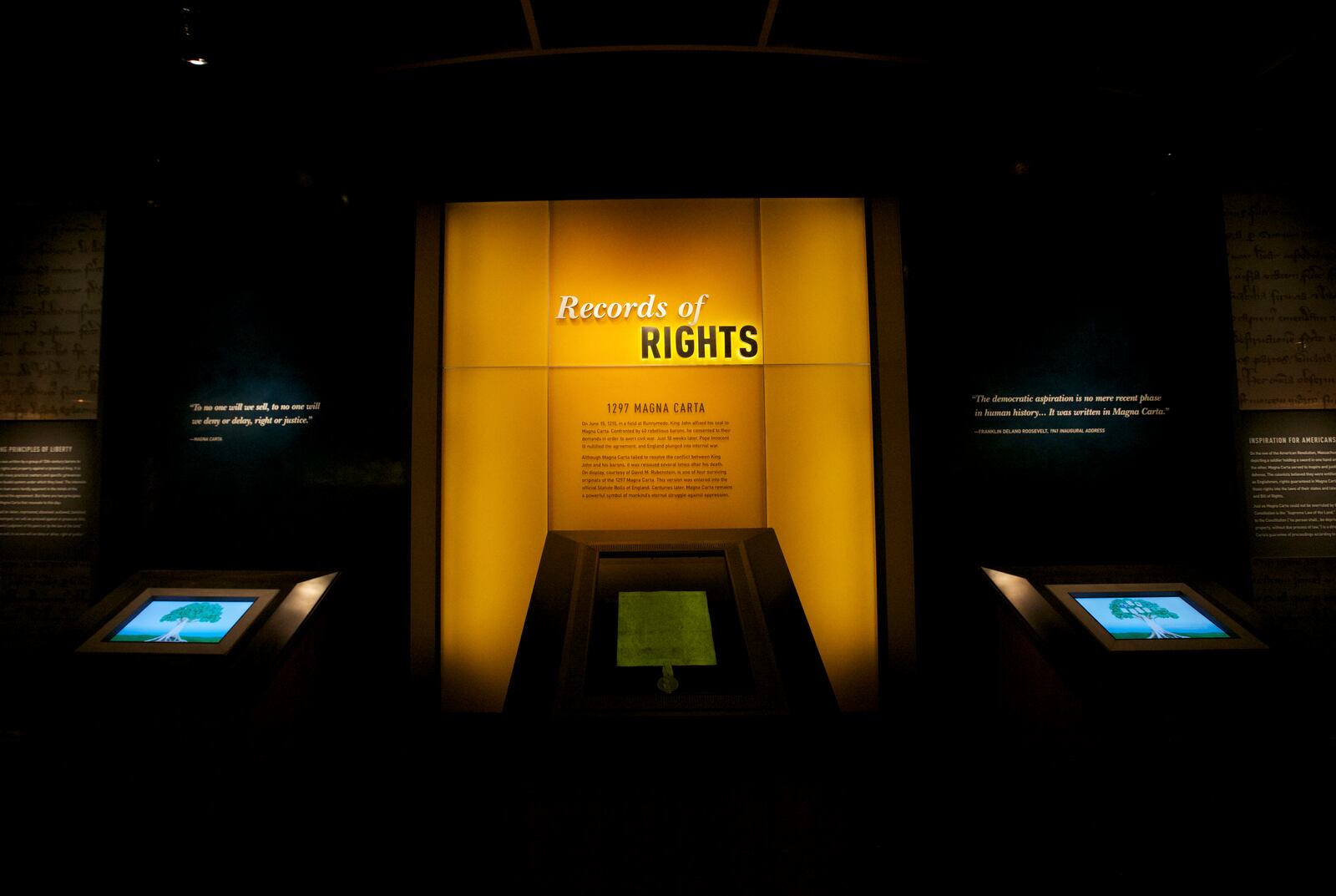 FILE - The Magna Carta is on display in glass case photographed during a press preview of the "Records of Rights" Permanent Exhibition in the new David M. Rubenstein Gallery at the National Archives in Washington, Dec. 11, 2013. (AP Photo/Molly Riley, File)