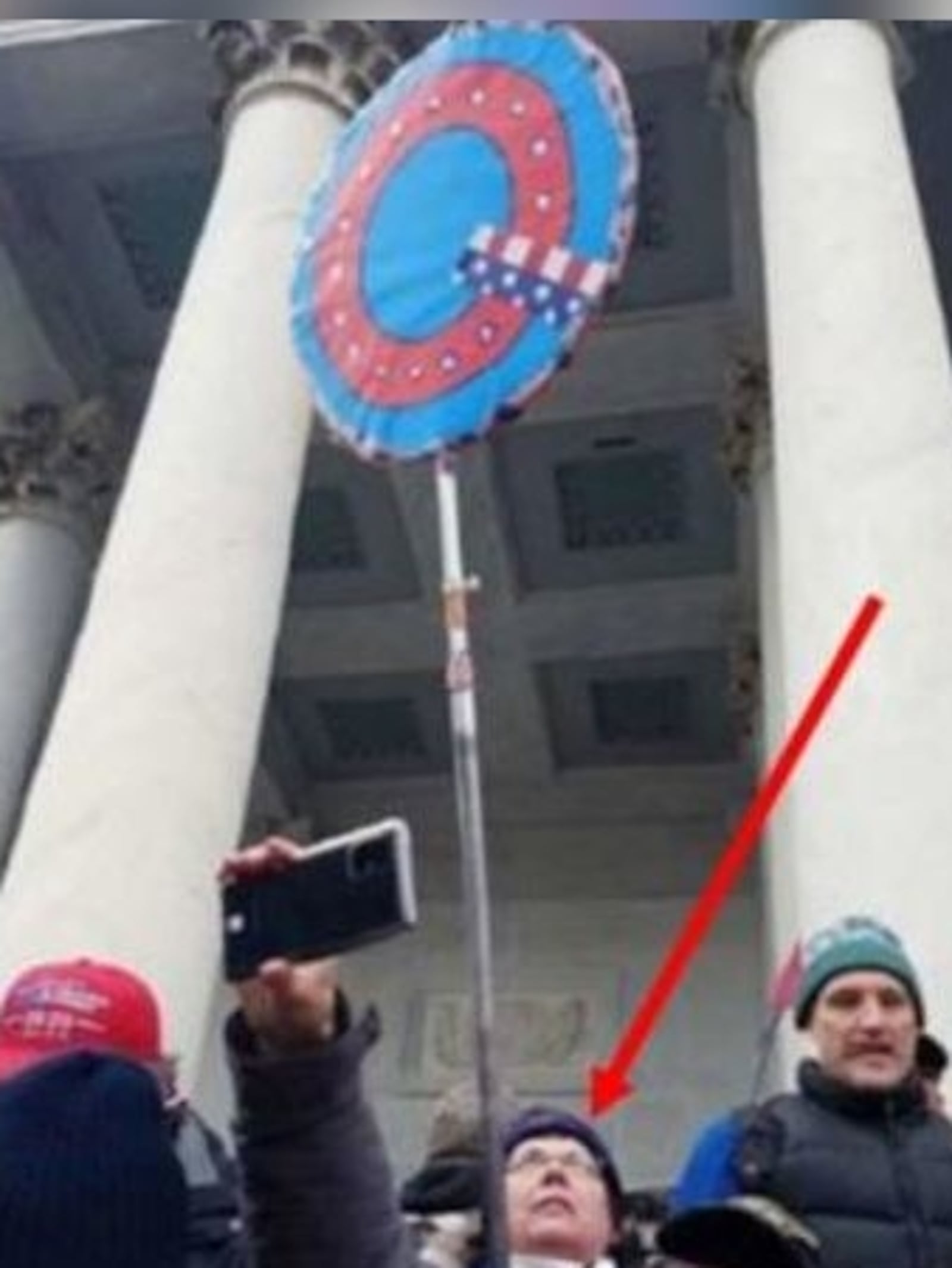 Jan. 6 U.S. Capitol riot: Therese Borgerding of Piqua is shown on the Capitol steps holding a "Q" sign in images filed in U.S. District Court for the District of Columbia.