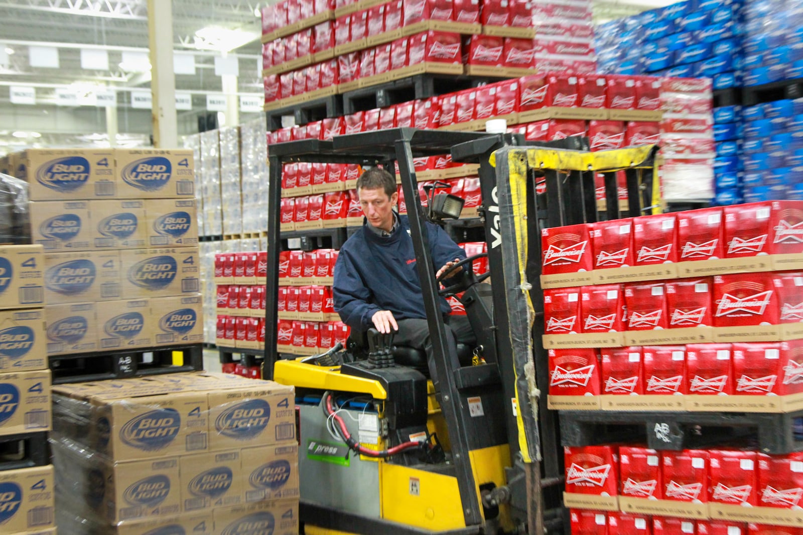 Steve Whitaker, a warehouse operations worker at Heidelberg Distributing, moves pallets of beer, July 15, inside the company's new distribution center in the former Cooper Tire building in Moraine. CHRIS STEWART / STAFF