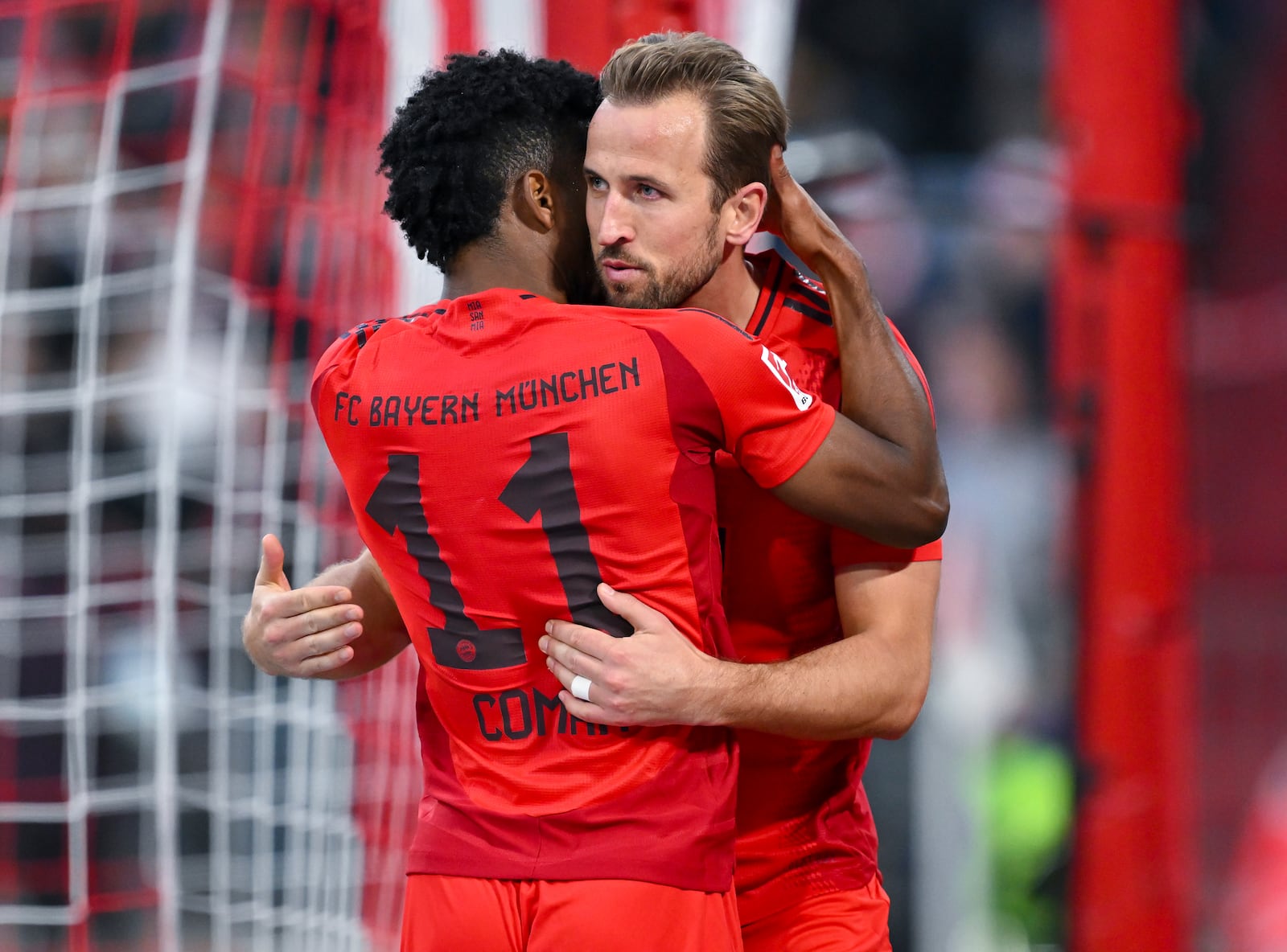 Munich's Kingsley Coman, left, celebrates scoring his side's second goal of the game with Harry Kane during the Bundesliga soccer match between Bayern Munich and Union Berlin at the Allianz Arena in Munich, Germany, Saturday, Nov. 2, 2024. (Sven Hoppe/dpa via AP)