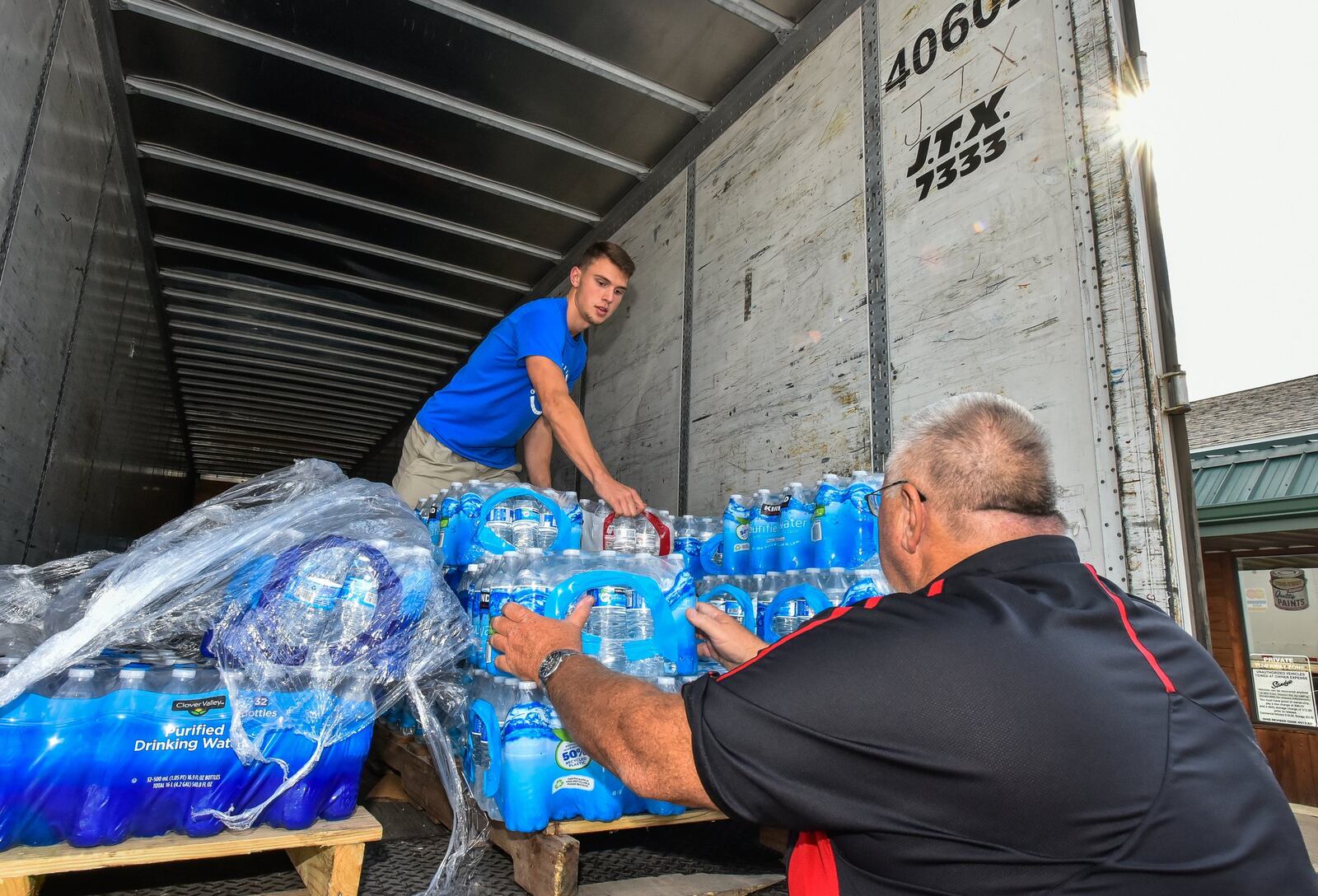 David Duncan, right, with JD Dispatch in Middletown, helps Joey Brown, 17, stack water that will be sent to Texas to help with Hurricane Harvey relief Thursday, Sept. 7 in Middletown. A semi truck filled with bottled water and supplies is being sent to a church in Humble, Texas to help give back to those in need after hurricane Harvey in Texas. Multiple businesses and individuals have donated toiletries, cleaning supplies, diapers, dog food and more to send. NICK GRAHAM/STAFF