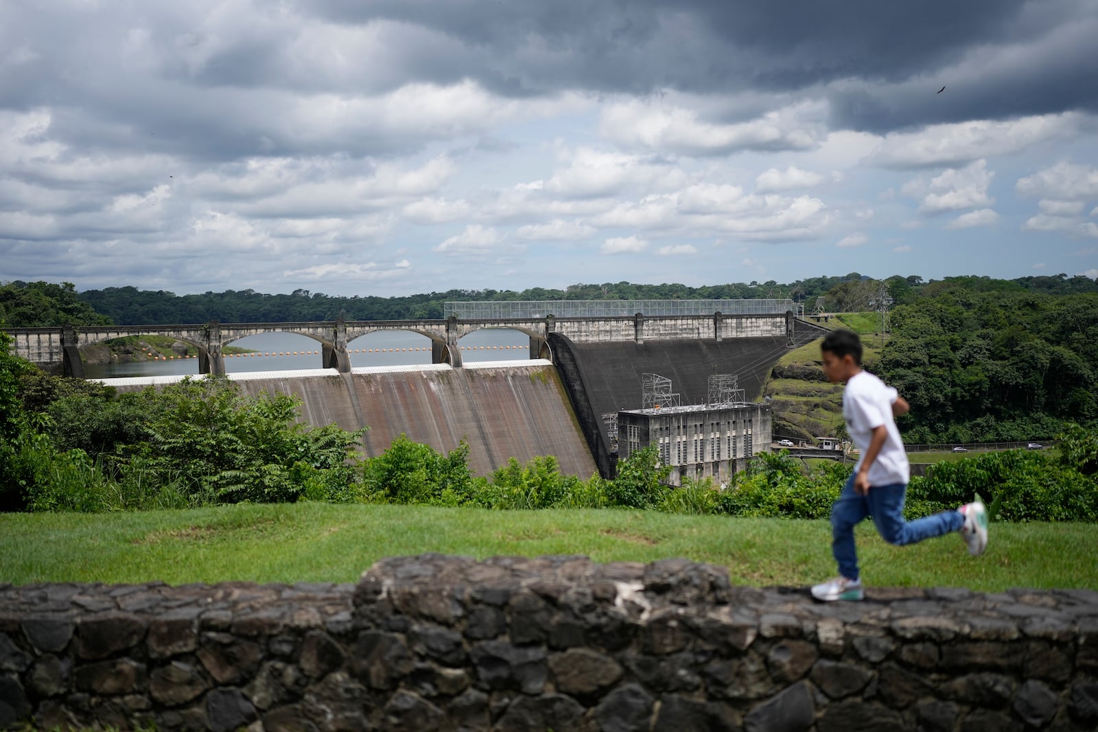 A youth runs near the Panama Canal's Madden Dam at Alajuela Lake in Colon, Panama, Monday, Sept. 2, 2024. (AP Photo/Matias Delacroix)