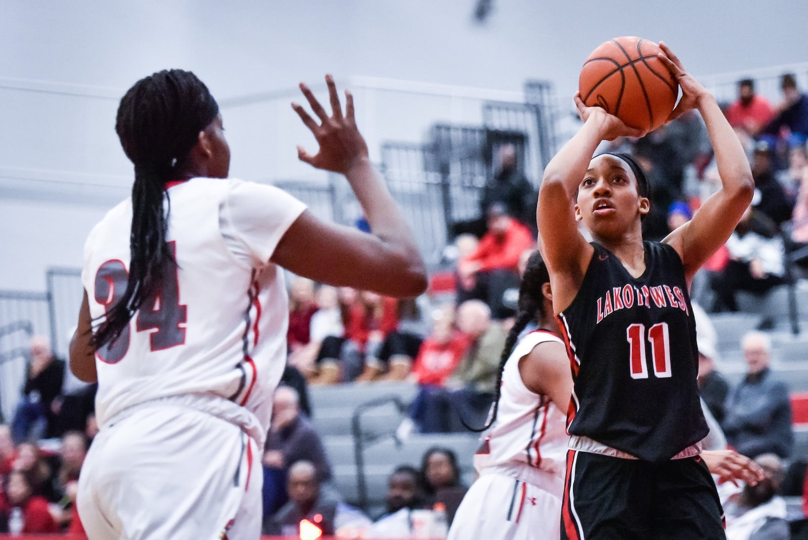 Lakota West’s Dominique Camp puts up a shot over Princeton’s Kyla Oldacre during West’s 61-50 road triumph in Sharonville on Wednesday night. It was the 400th victory of coach Andy Fishman’s career. NICK GRAHAM/STAFF