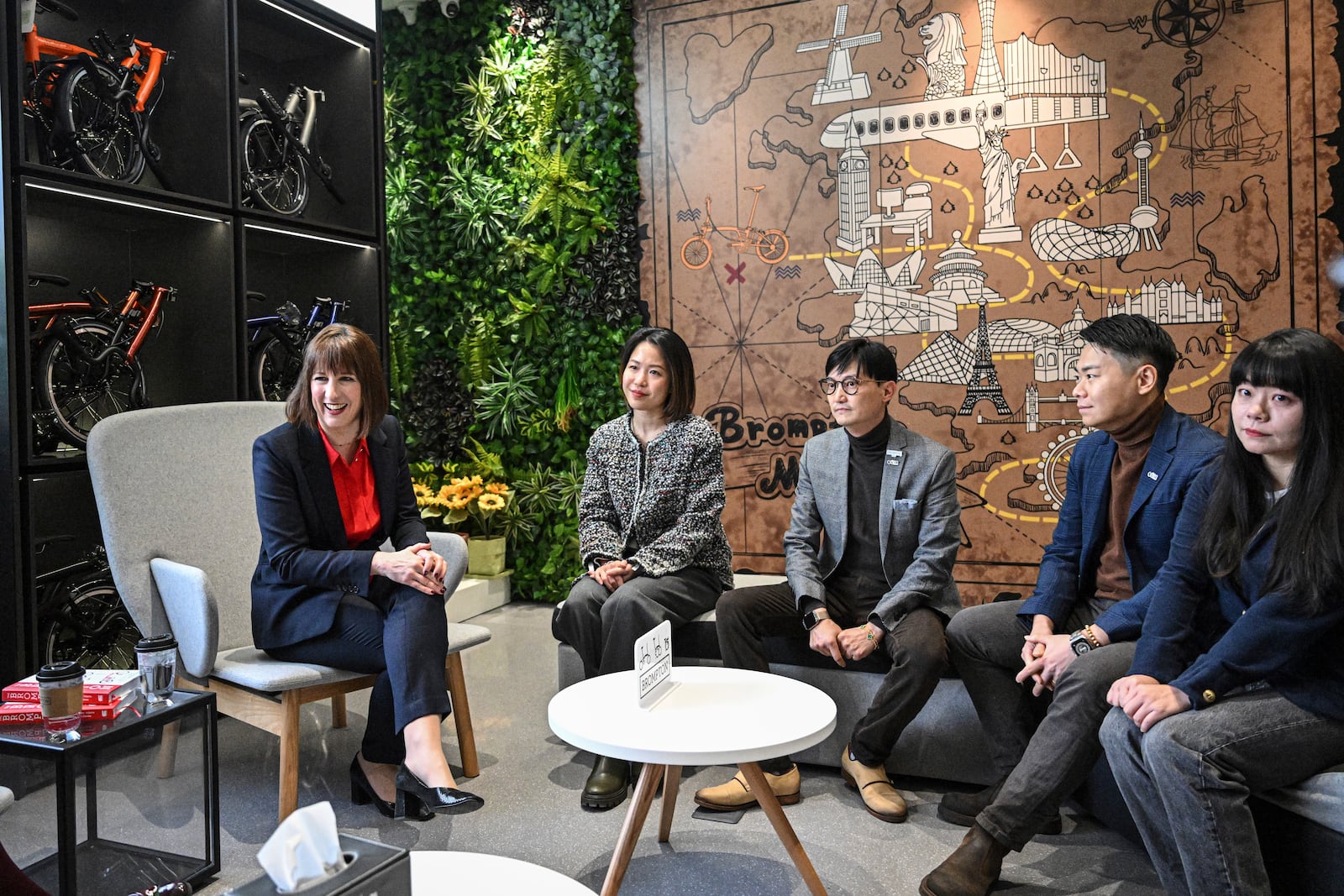 Britain's Chancellor of the Exchequer Rachel Reeves, 1st left, talks with the employees of Brompton flagship store in Beijing, Saturday, Jan. 11, 2025. (Jade Gao/Pool Photo via AP)