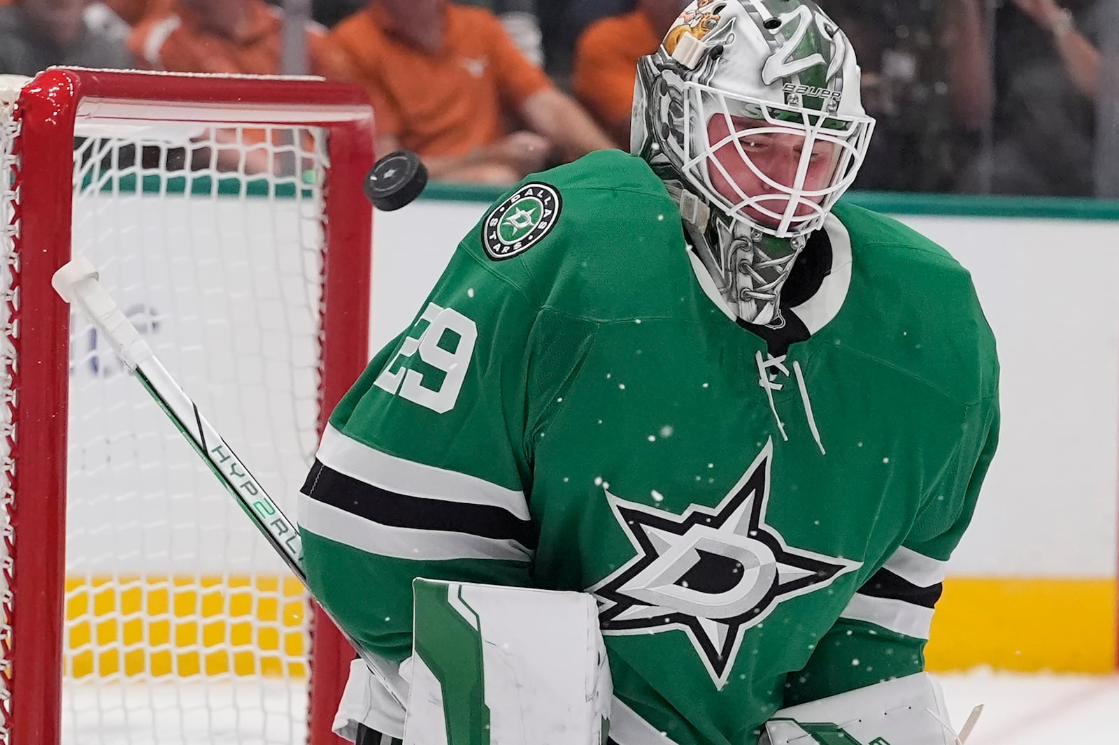 Dallas Stars goaltender Jake Oettinger (29) deflects a shot on goal during the second period of an NHL hockey game against the New York Islanders, Saturday, Oct. 12, 2024, in Dallas. (AP Photo/LM Otero)