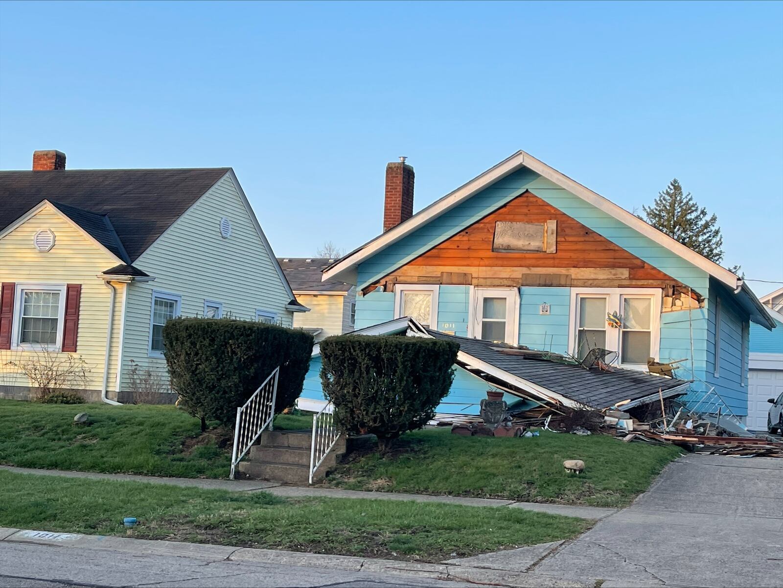 A vehicle crashed into a Hamilton house at Park and Haven Monday ripping off the porch. MANDY GAMBRELL/STAFF