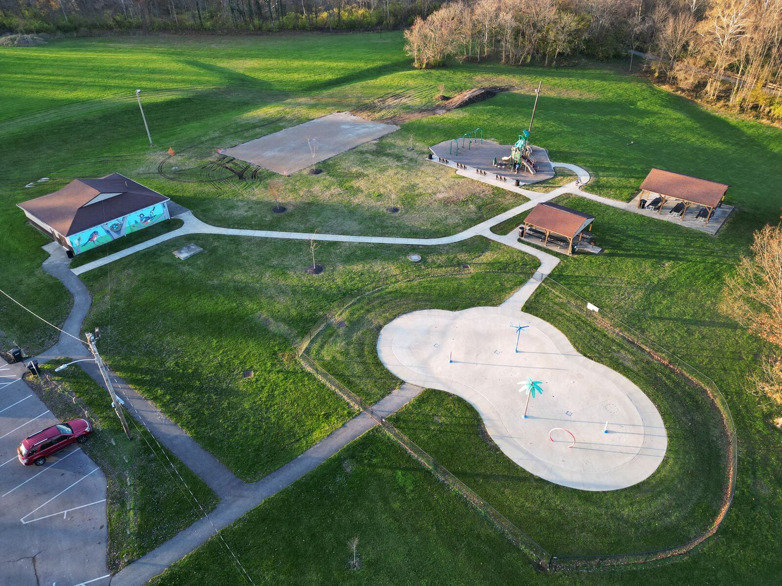 The Hamilton Parks Conservancy District is installing a basketball court at Jim Grimm Park, which is a direct result of four high school students in March 2023 asked City Council for more activities for residents their age. Hamilton worked with the Parks Conservancy District and are addressing those concerns, needs and wants in the community, including this basketball court, which could be ready for use as early as by the end of this year. A gravel based has been laid for the court, pictured here in the upper center-left, before asphalt is poured. NICK GRAHAM/STAFF