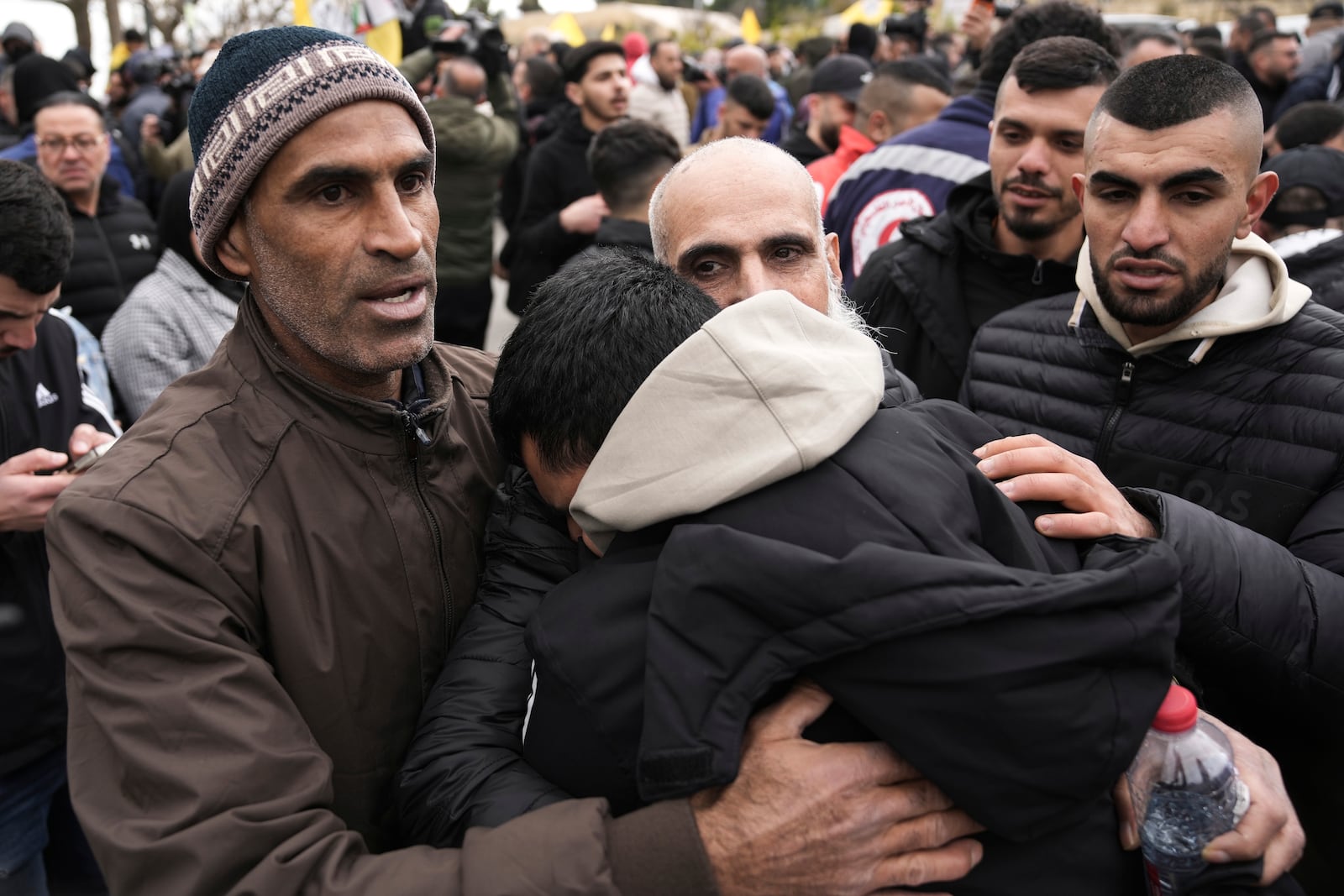 Palestinian prisoners are greeted as they exit a Red Cross bus after being released from Israeli prison following a ceasefire agreement between Israel and Hamas, in the West Bank city of Ramallah, Saturday Feb. 8, 2025. (AP Photo/Mahmoud Illean)