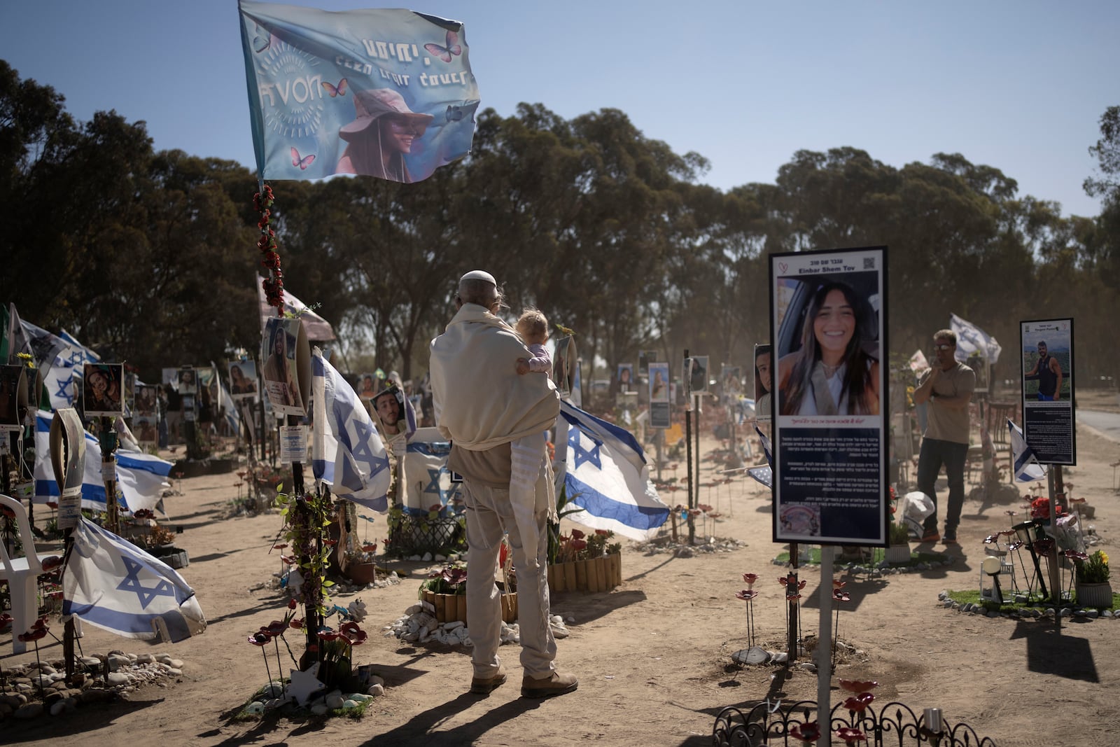 A man in prayer shawl visits the site of the Nova music festival, where hundreds of revelers were killed or kidnapped by Hamas, on the Jewish holiday of Simchat Torah, marking one year in the Hebrew calendar since the attack, near Kibbutz Re'im, southern Israel near the Gaza Strip, Thursday, Oct. 24, 2024. (AP Photo/Maya Alleruzzo)