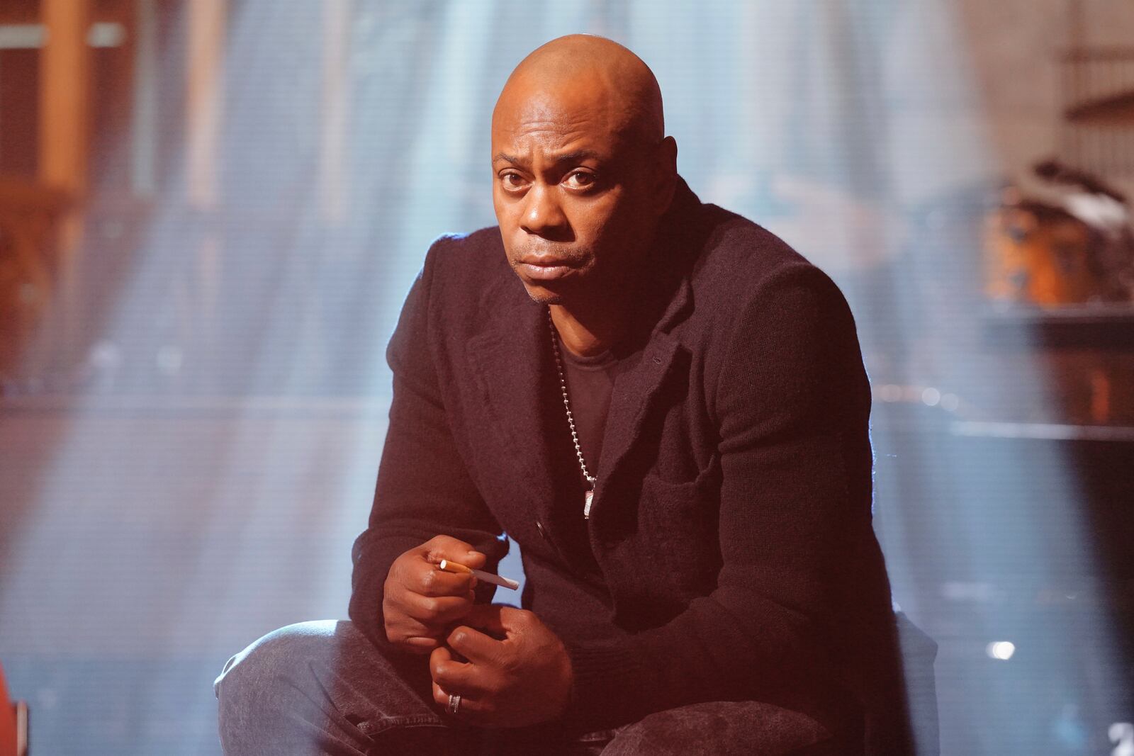 This image released by NBC shows host Dave Chappelle taping promos for his upcoming appearance on "Saturday Night Live," on Tuesday, Jan. 14, 2025, in New York. (Rosalind O'Connor/NBC via AP)