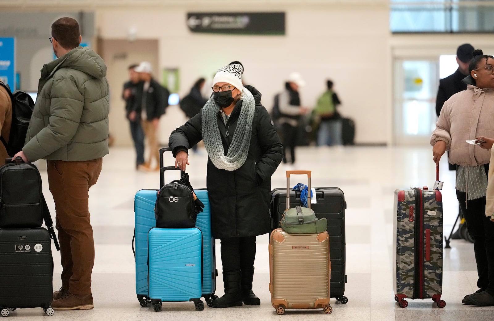 People are shown waiting in line at the Delta ticket counter in Terminal A at George Bush Intercontinental Airport Wednesday, Jan. 22, 2025, in Houston. Both Houston airports reopened Wednesday after being closed on Tuesday due to the winter storm. (Melissa Phillip/Houston Chronicle via AP)