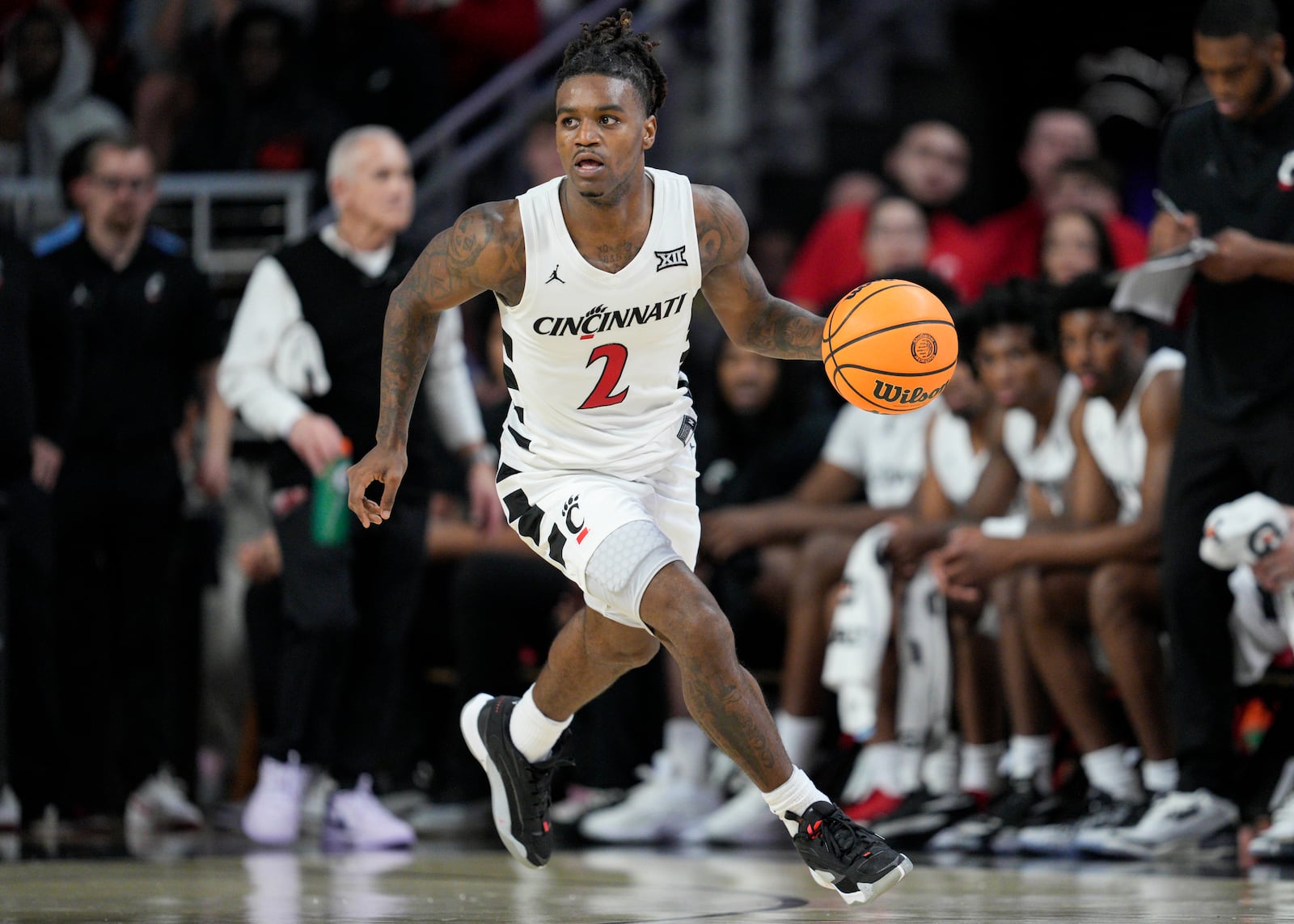 Cincinnati guard Jizzle James (2) dribbles during the first half of an NCAA college basketball game against Arkansas-Pine Bluff, Monday, Nov. 4, 2024, in Cincinnati. (AP Photo/Jeff Dean)