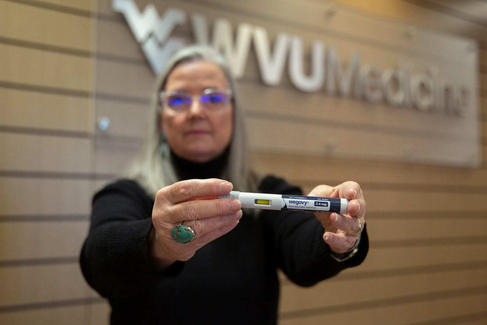 Patient Lory Osborn holds a Wegovy pen used in her treatment at the Medical Weight Management office at West Virginia University in Morgantown, W.Va., Monday, Dec. 2, 2024. (AP Photo/Kathleen Batten)