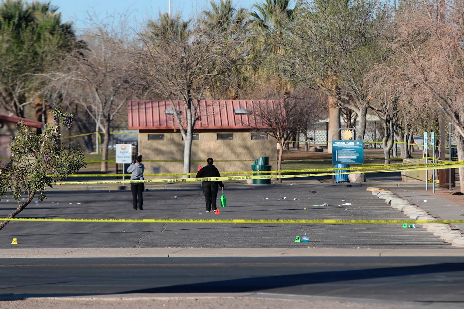 Crime scene technicians look over the Young Park parking lot after a mass shooting overnight, Saturday, March 22, 2025 in Las Cruces, N.M. (Justin Garcia/The Albuquerque Journal via AP)