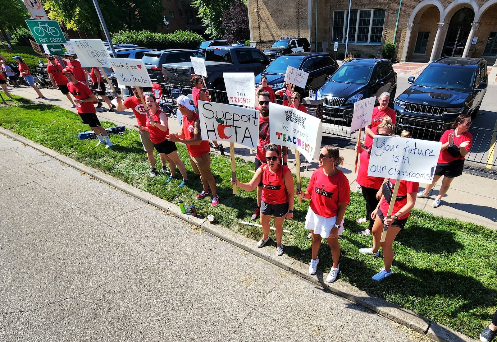 Hamilton teachers gathered along Dayton Street in front of the Hamilton City School District building to demonstrate for fair pay for teachers Wednesday, June 22, 2022. NICK GRAHAM/STAFF