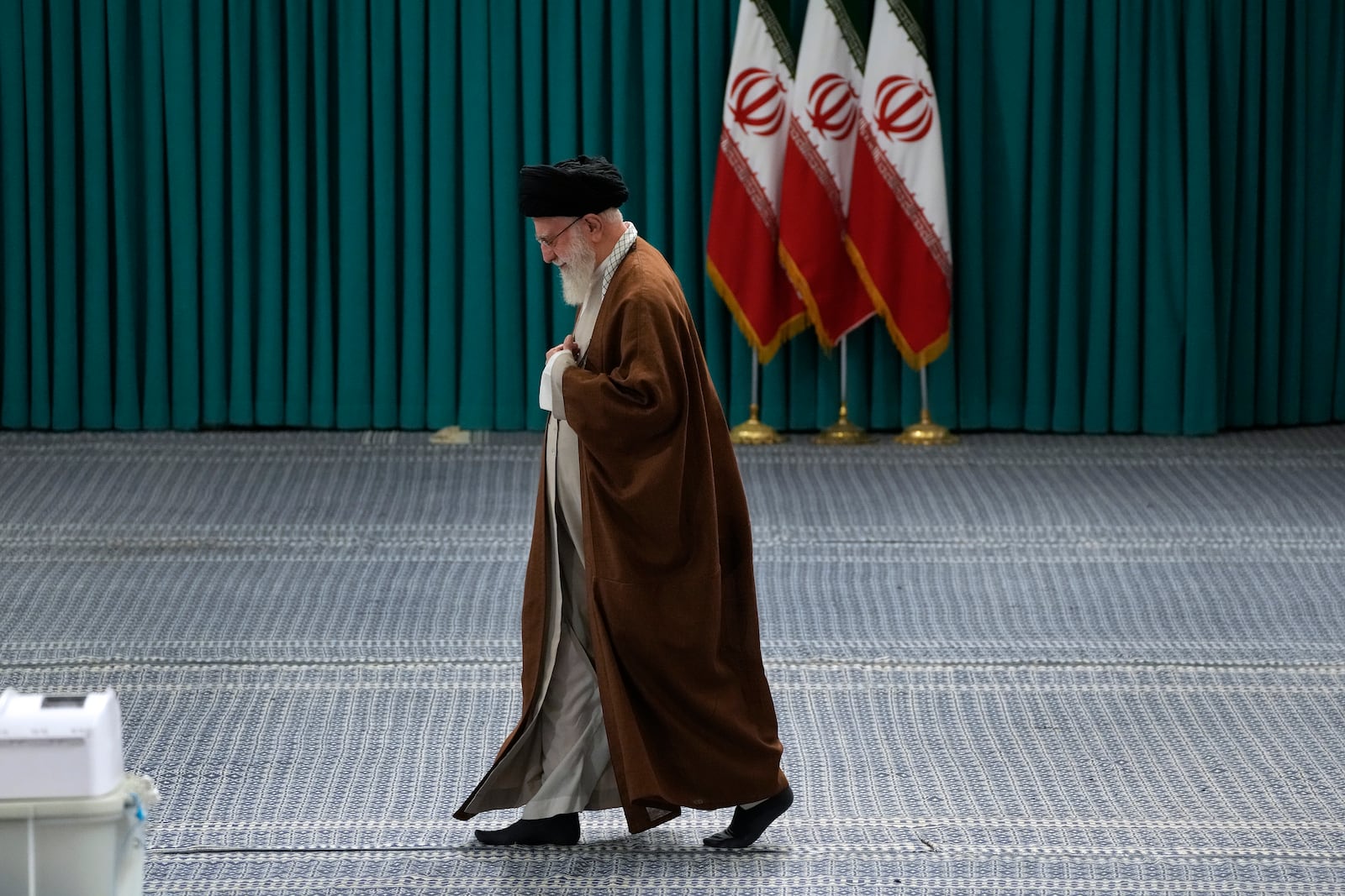 FILE - Iranian Supreme Leader Ayatollah Ali Khamenei arrives to vote for the parliamentary runoff elections, in Tehran, Iran, Friday, May 10, 2024. (AP Photo/Vahid Salemi, File)