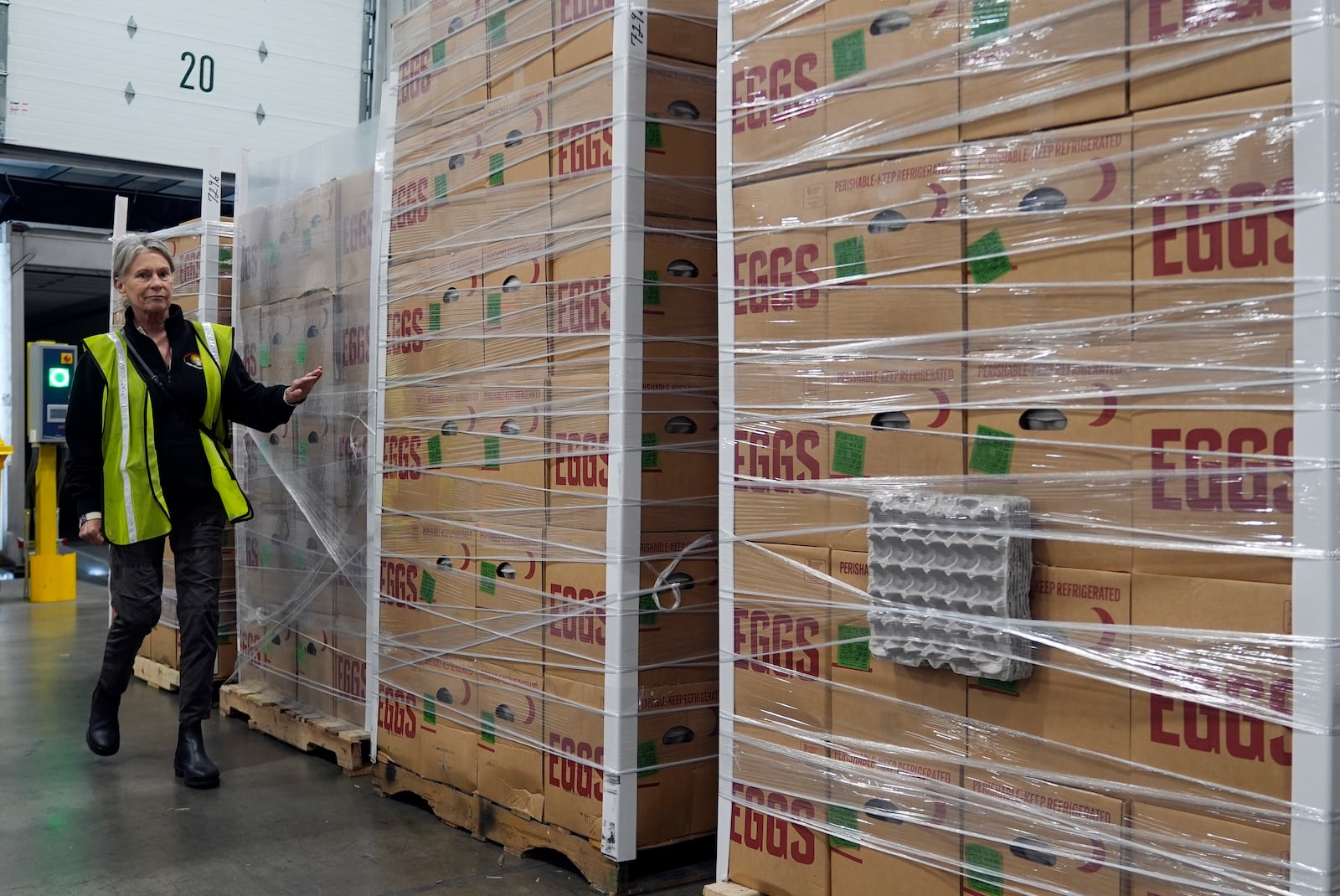 Rosemary Farm family representative Lisa Stothart checks pallets delivered with hundreds of thousands of fresh eggs donated by Rosemary Farm to feed first responders and those in need in the community at the Los Angeles Food Regional Bank in City of Industry, Calif., on Wednesday, Feb. 12, 2025. (AP Photo/Damian Dovarganes)