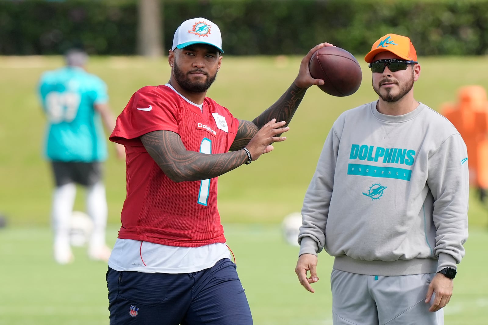 Miami Dolphins quarterback Tua Tagovailoa (1) aims a pass during a practice session at the team's training facility, Wednesday, Oct. 23, 2024, in Miami Gardens, Fla. (AP Photo/Marta Lavandier)