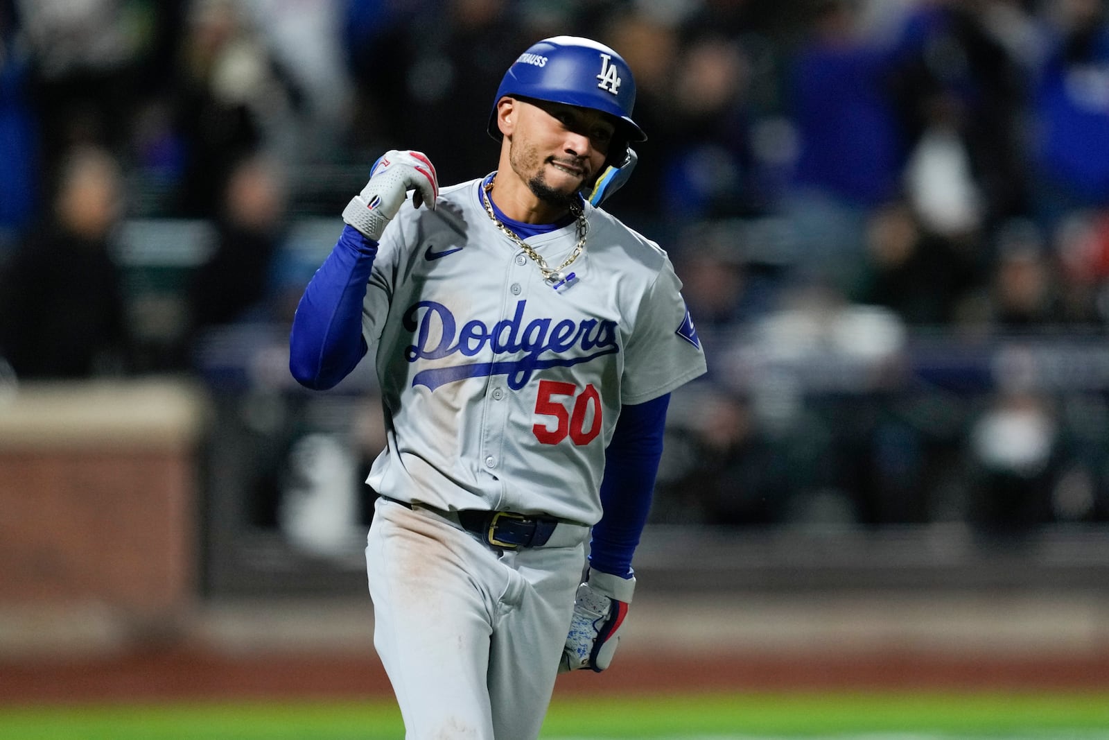 Los Angeles Dodgers' Mookie Betts celebrates after a two-run home run against the New York Mets during the seventh inning in Game 4 of a baseball NL Championship Series, Thursday, Oct. 17, 2024, in New York. (AP Photo/Ashley Landis)