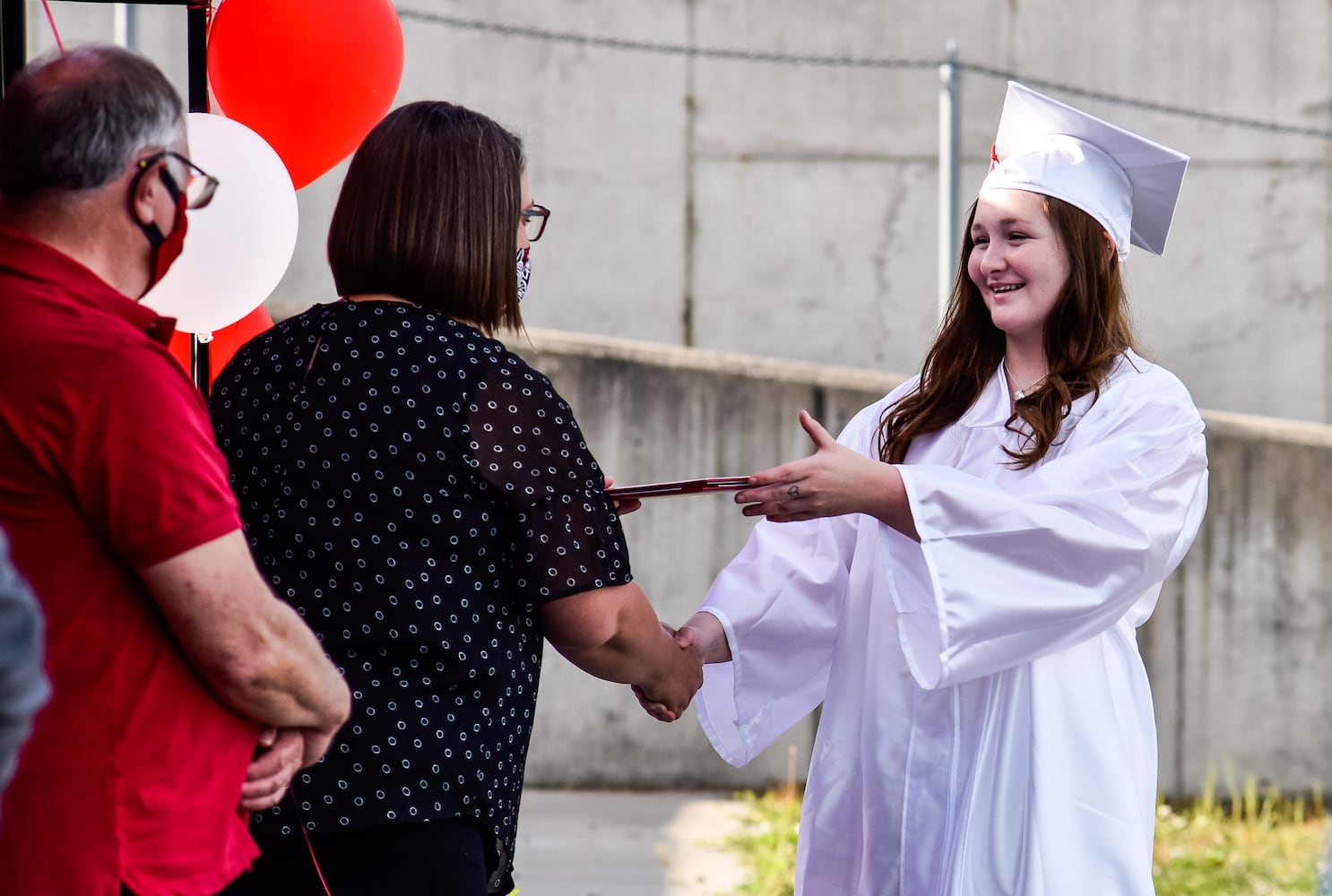 Madison High School drive-thru graduation ceremony at Land of Illusion