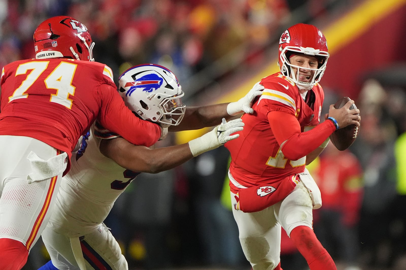 Kansas City Chiefs quarterback Patrick Mahomes (15) scrambles during the first half of the AFC Championship NFL football game against the Buffalo Bills, Sunday, Jan. 26, 2025, in Kansas City, Mo. (AP Photo/Charlie Riedel)