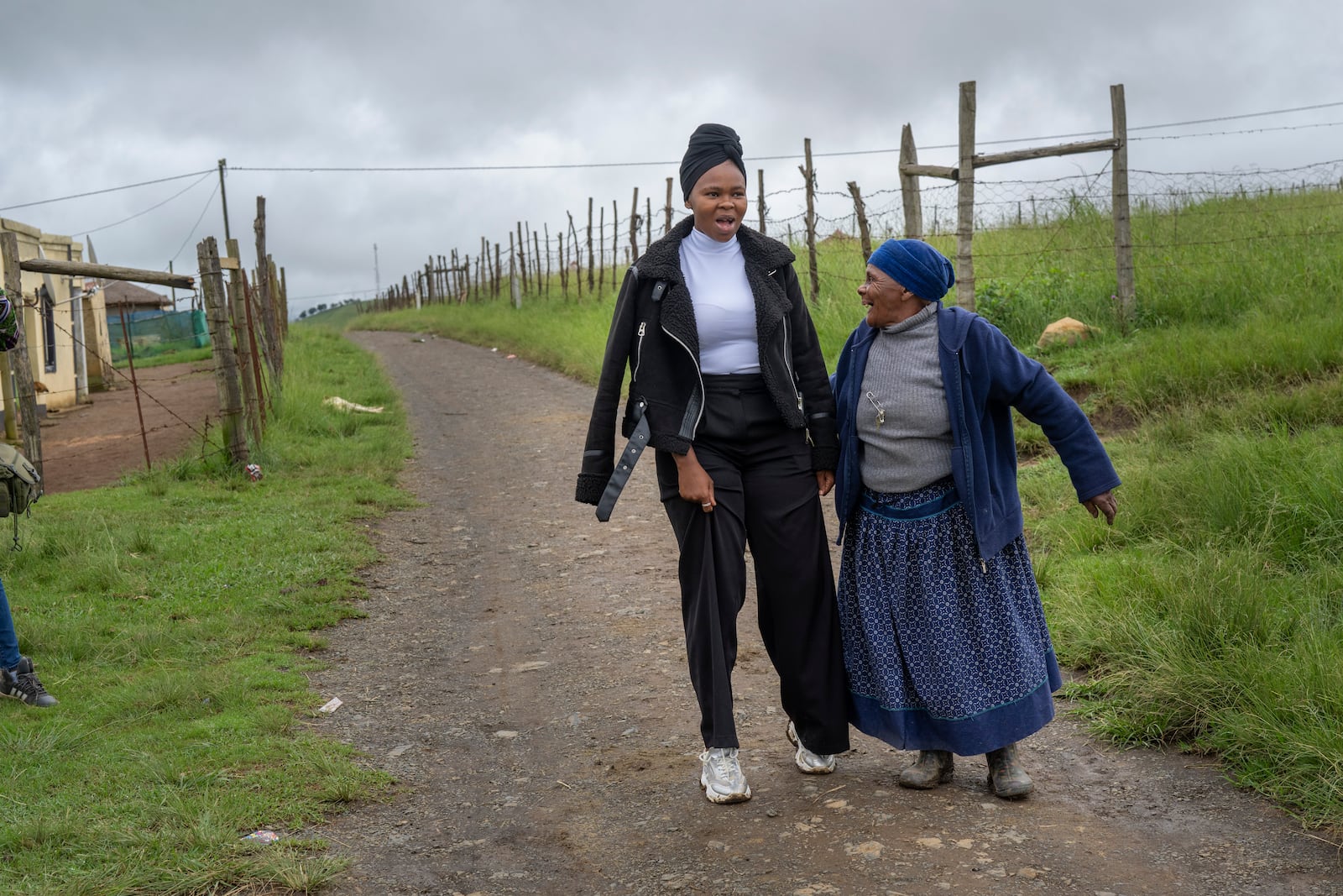 Unemployed 19-year-old South African Nozuko Majola, one of millions of patients in South Africa affected by U.S. President Donald Trump's global foreign aid freeze, raising worries about HIV patients defaulting on treatment, is greeting by a neighbour , near her Umzimkhulu home, Tuesday, Nov. 11, 2025. (AP Photo/Jerome Delay}