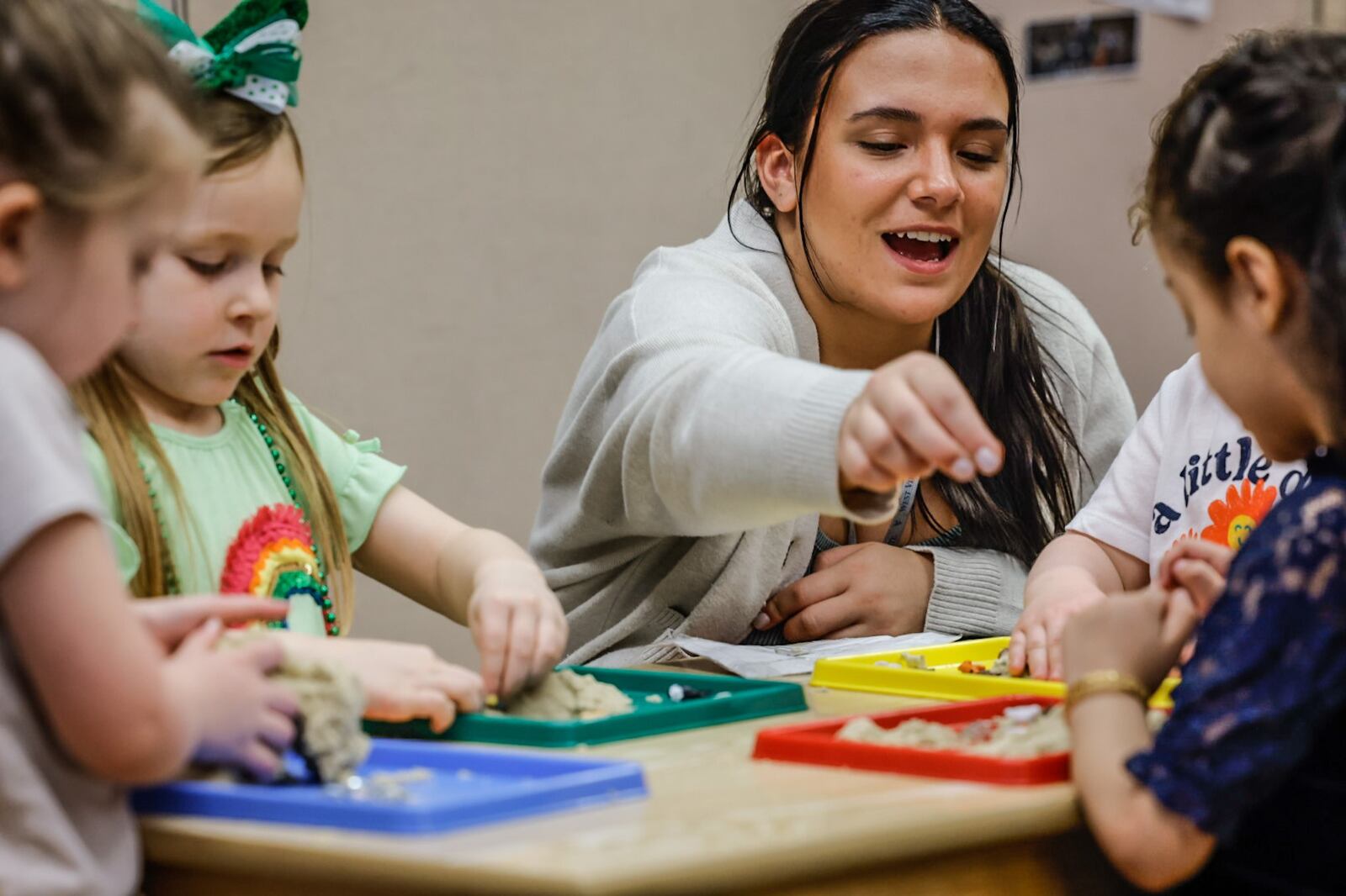 Mini University at Sinclair Community College PreK teacher, Christine Nesbitt works with children Wednesday April 5, 2023. JIM NOELKER/STAFF