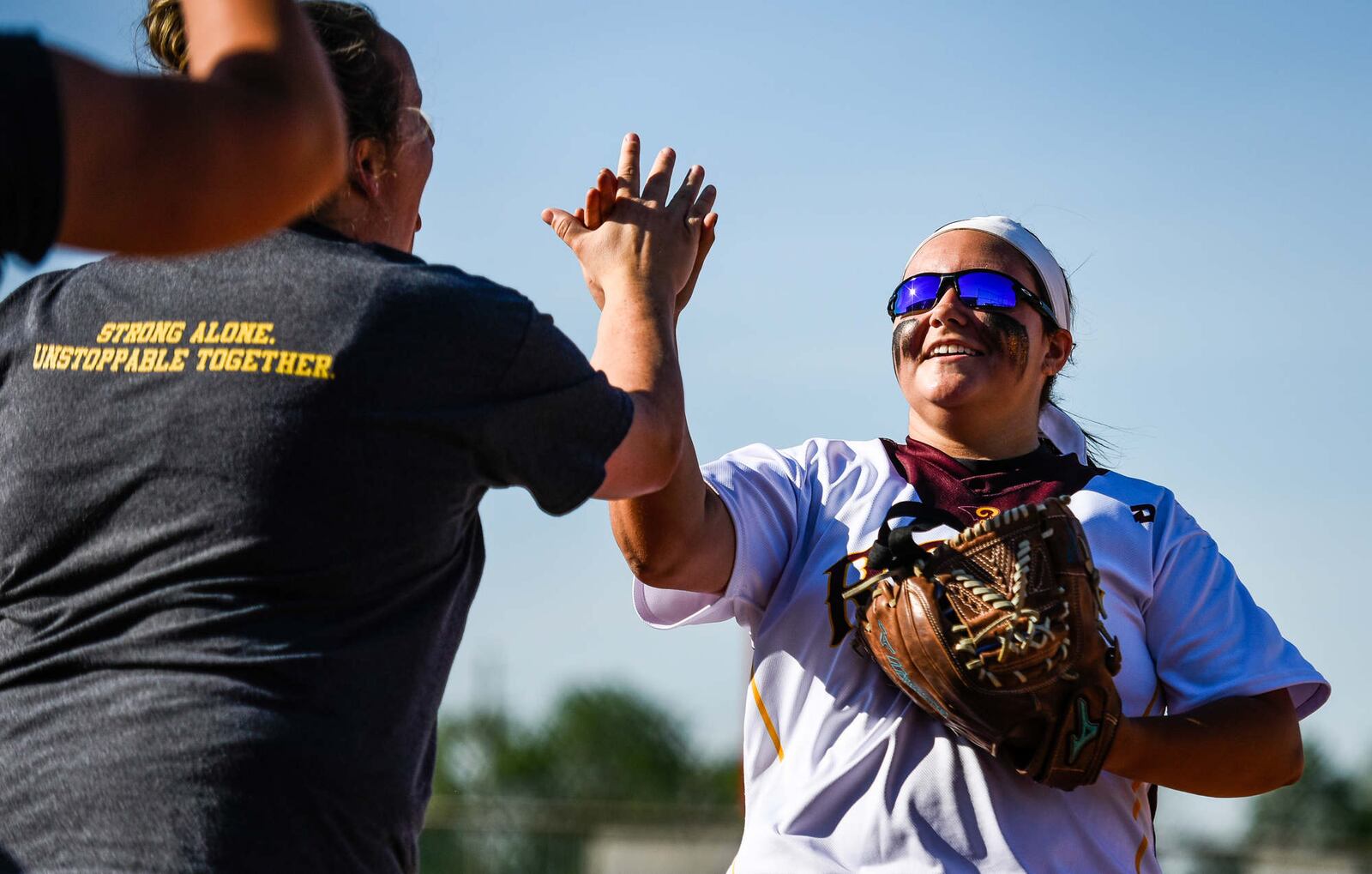 Ross pitcher Kenzie Meyer is congratulated by Rams coach Anna Winters during Tuesday’s Division II sectional final against Wilmington at Kings. NICK GRAHAM/STAFF