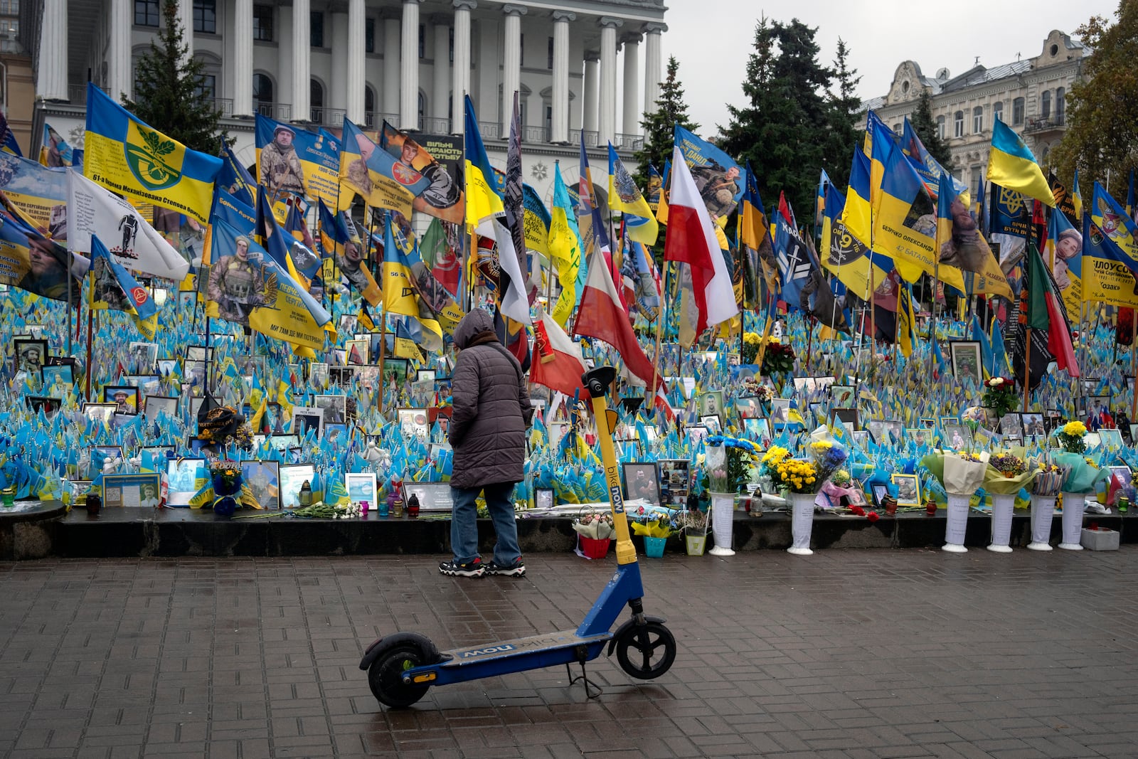 A woman looks at the memorial to fallen soldiers in Independence Square in Kyiv, Ukraine, Friday, Nov. 15, 2024. (AP Photo/Efrem Lukatsky)