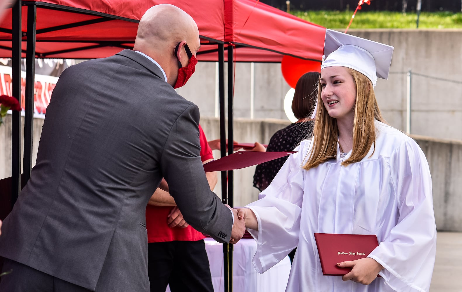 Madison High School drive-thru graduation ceremony at Land of Illusion