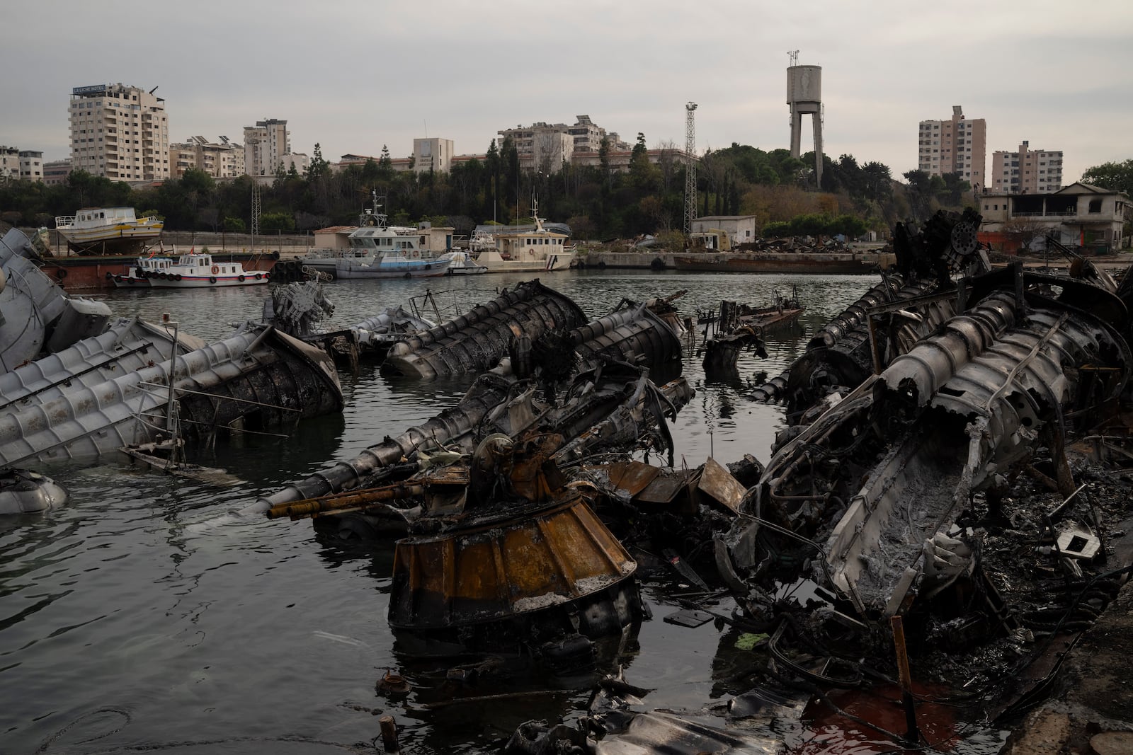 Destroyed Syrian naval vessels from previous Israeli airstrikes are seen in the port of Latakia, Syria, Monday, Dec. 16, 2024. (AP Photo/Leo Correa)