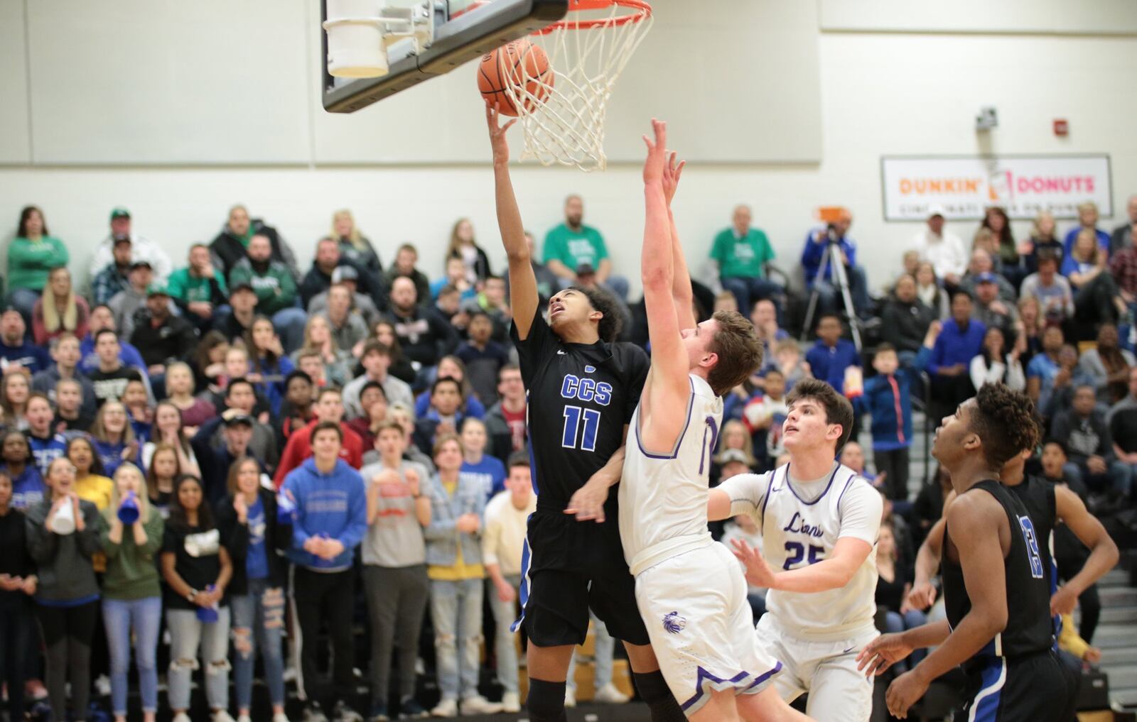 Cincinnati Christian’s Logan Woods (11) puts up a close-range shot during Saturday night’s Division IV district semifinal against Miami Valley Christian Academy at Taylor. CCS won 55-40. PHOTO BY KRAE/WWW.KRAEPHOTOGRAPHY.COM