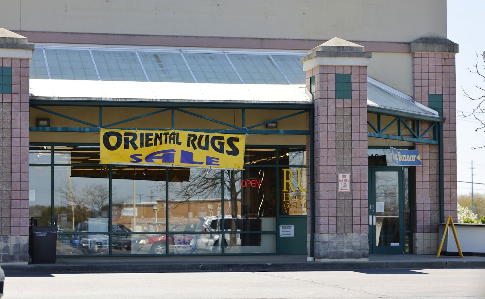 Rug Bazaar in West Chester Township has signs on their building and a temporary blade sign in the grass at the intersection of Union Centre Boulevard and Princeton Glendale Road. NICK GRAHAM/STAFF