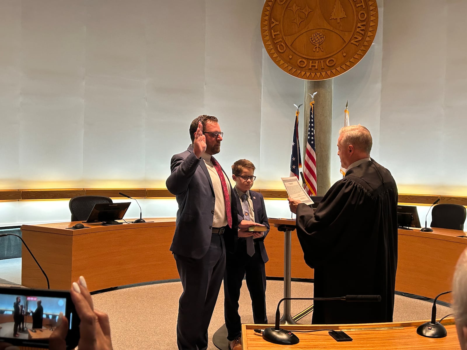 Steve West II is sworn-in Tuesday night as a Middletown City Council member by Municipal Court Judge James Sherron. His son, Christopher, 11, holds the Bible. RICK McCRABB/STAFF