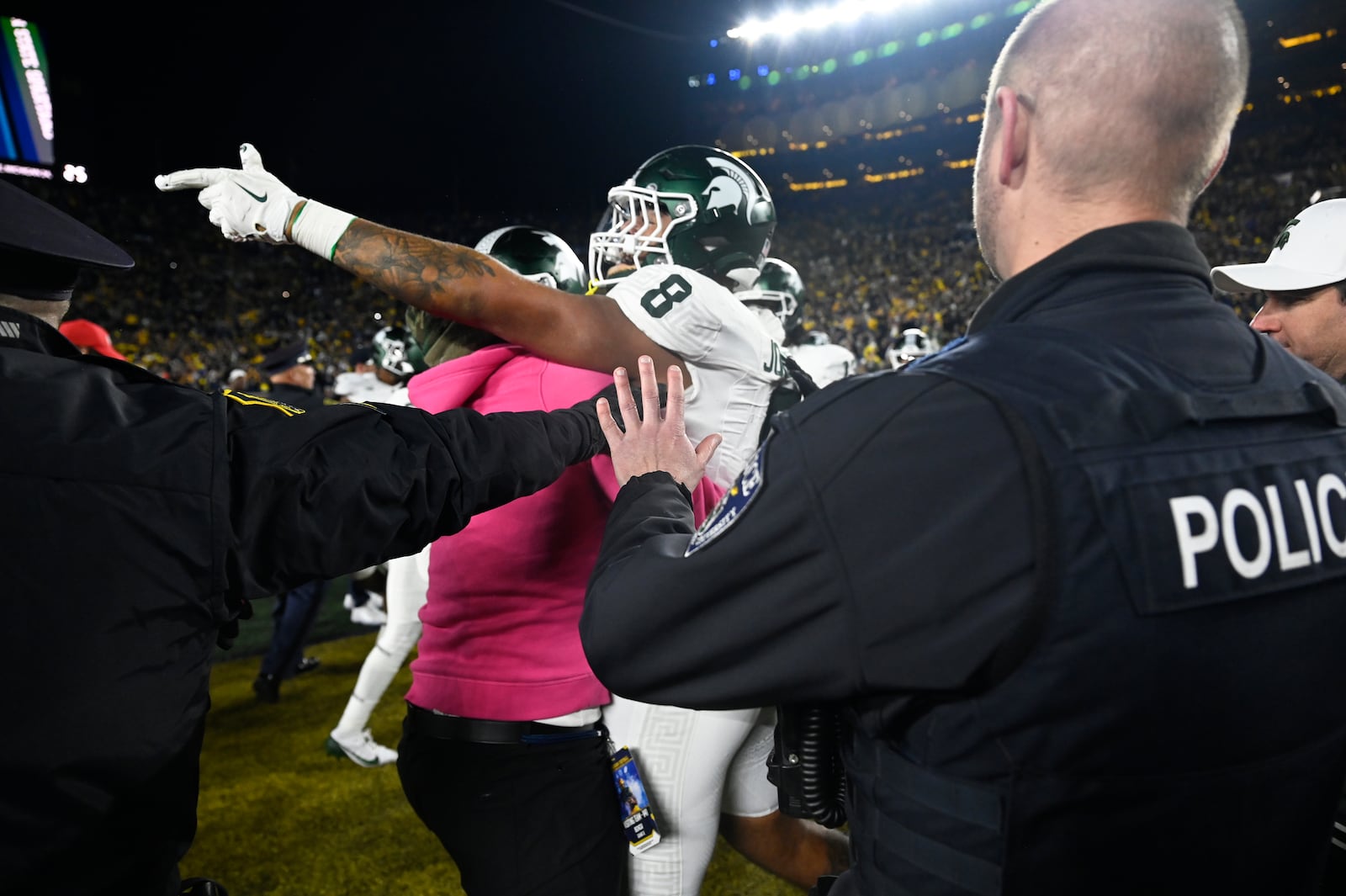 Michigan State defensive lineman Anthony Jones (8) is held back by team personnel after a fight broke out with Michigan following an NCAA college football game, Saturday, Oct. 26, 2024, in Ann Arbor, Mich. (AP Photo/Jose Juarez)