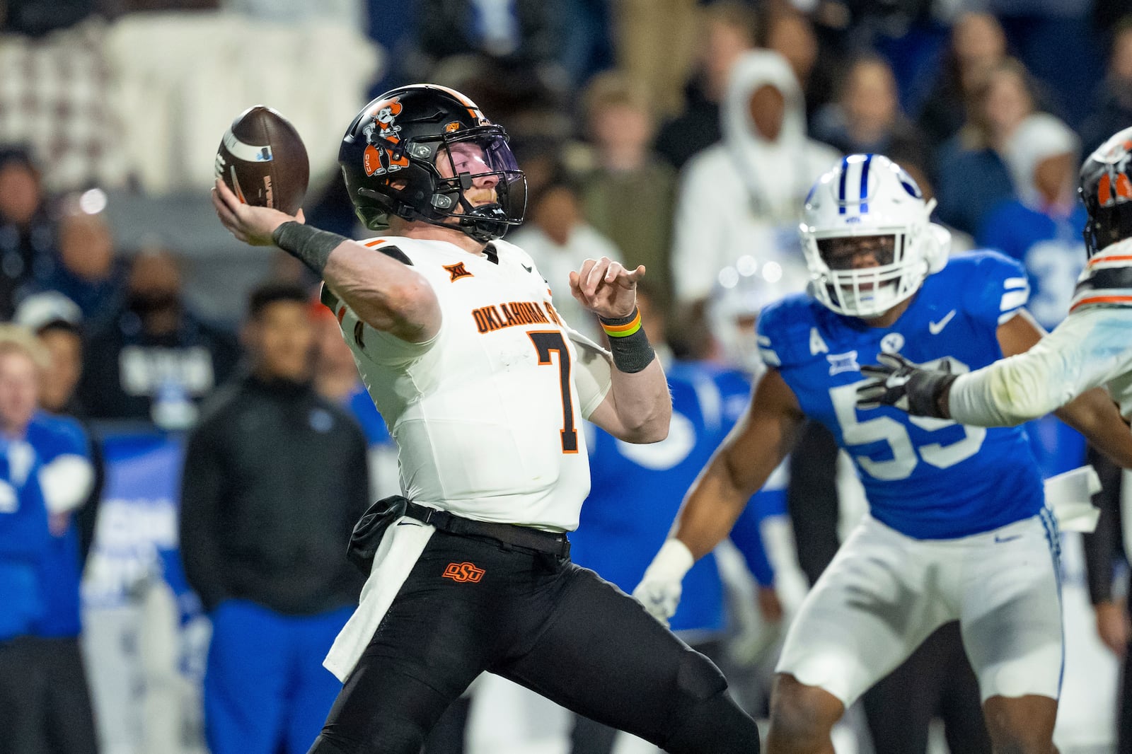 Oklahoma State quarterback Alan Bowman passes in the second half of an NCAA college football game against BYU, Friday, Oct. 18, 2024, in Provo, Utah. (AP Photo/Spenser Heaps)