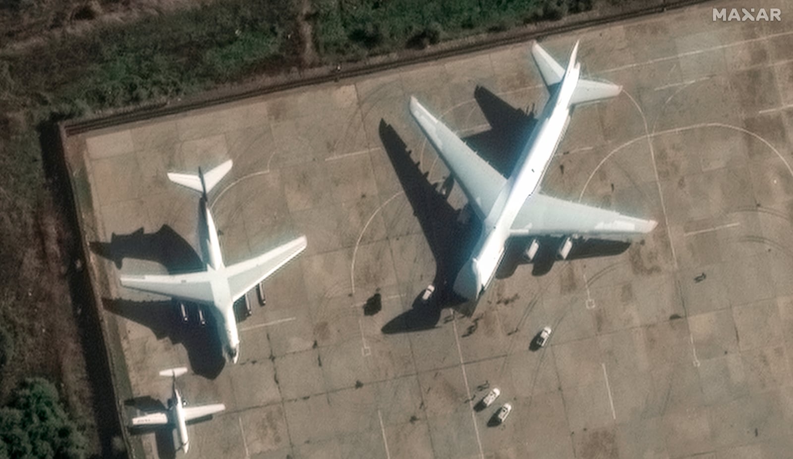 This satellite image provided by Maxar Technologies shows heavy transport aircraft preparing to load equipment at the Russian Hemeimeem airbase in Latakia, Syria on Friday, Dec. 13, 2024. (Maxar Technologies via AP)