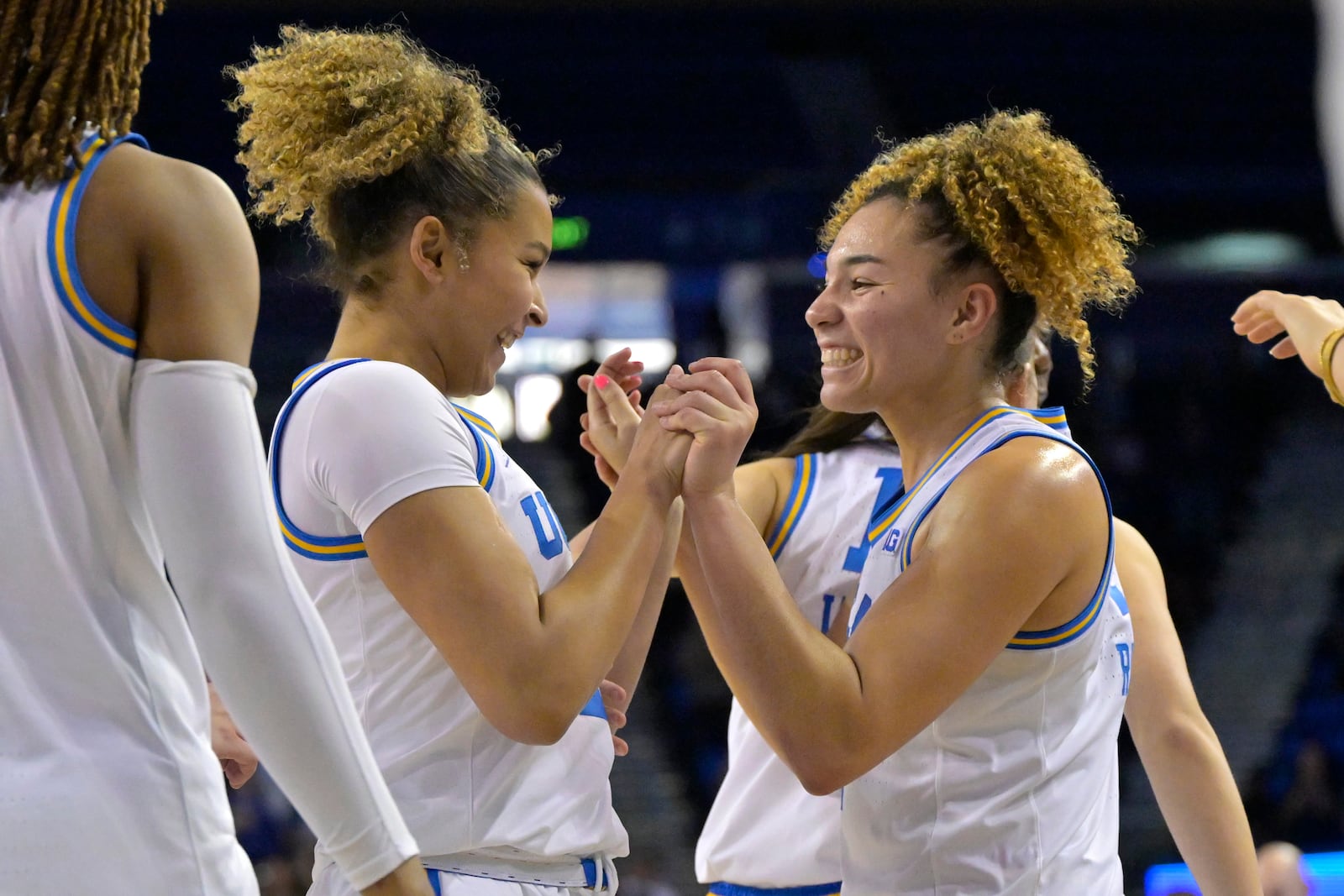 UCLA guards Avary Cain, left, and Kiki Rice, right, celebrate after defeating Minnesota in an NCAA college basketball game Sunday, Feb. 2, 2025, in Los Angeles. (AP Photo/Jayne Kamin-Oncea)