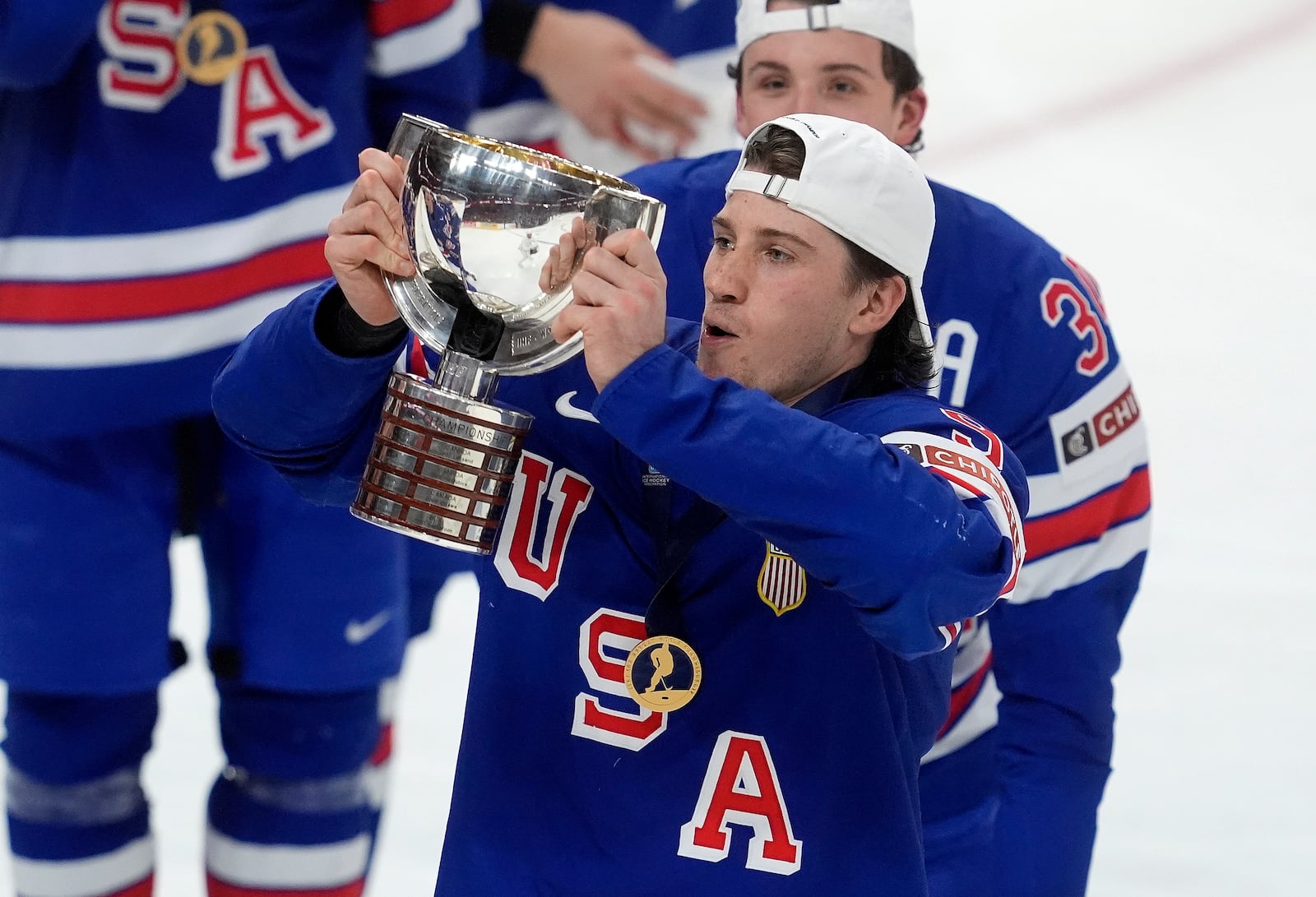 United States forward Ryan Leonard (9) hoists the trophy following their IIHF World Junior Hockey Championship gold medal game win over Finland in Ottawa, Ontario, Sunday, Jan. 5, 2025. (Adrian Wyld/The Canadian Press via AP)