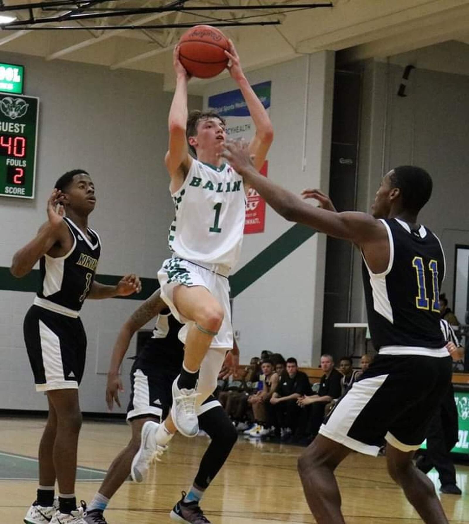 Badin’s Joseph Walsh shoots over Keyshawn Bourrage (11) of Northwest during Tuesday night’s game at Mulcahey Gym in Hamilton. Badin won 70-52. CONTRIBUTED PHOTO BY TERRI ADAMS