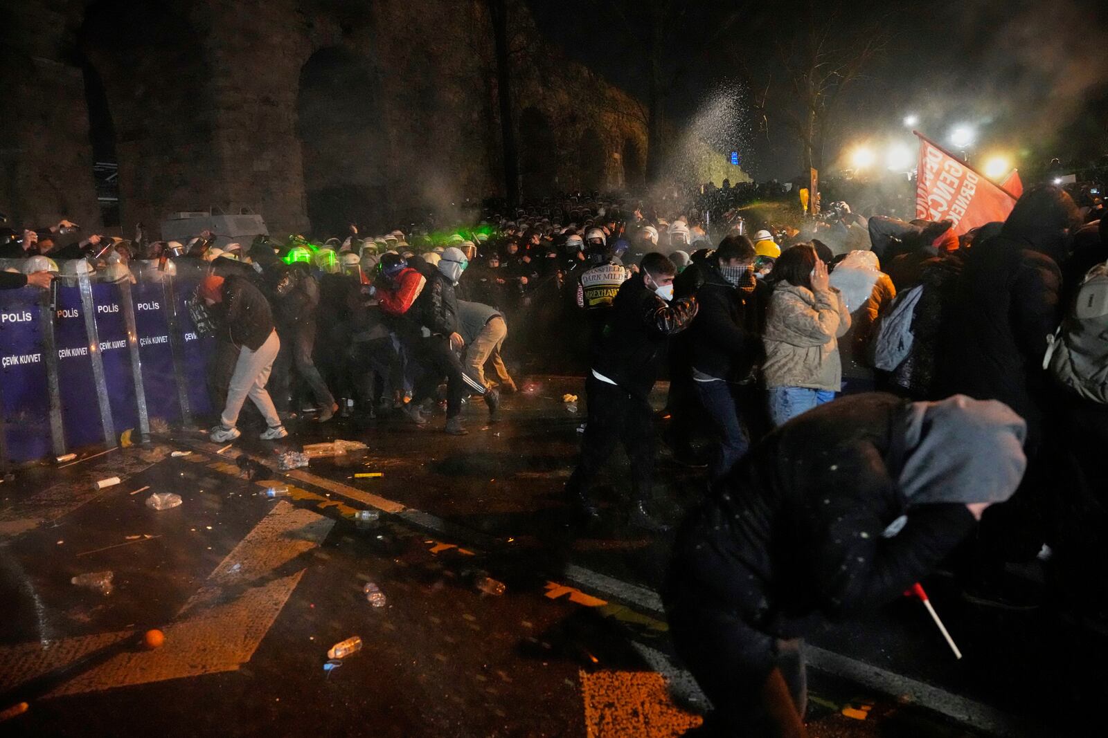 Police officers use pepper spray during clashes with people as they protest against the arrest of Istanbul's Mayor Ekrem Imamoglu, in Istanbul, Turkey, Friday, March 21, 2025. (AP Photo/Khalil Hamra)