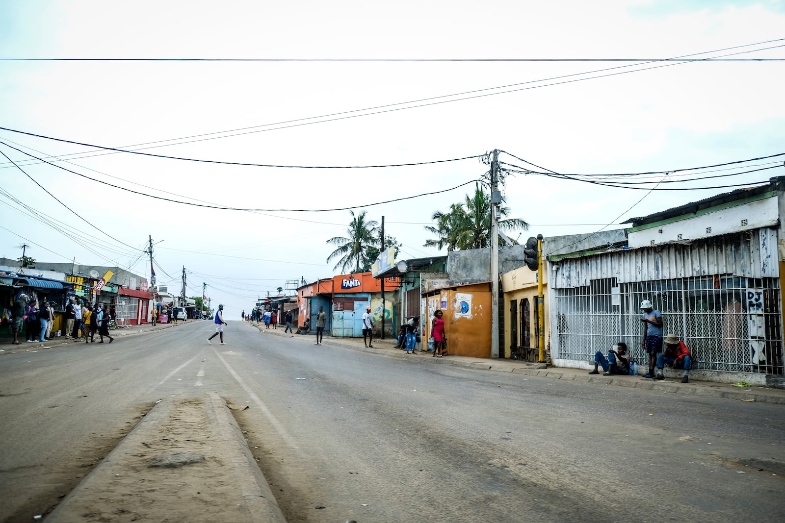 A lone man crosses the empty streets of Maputo, Mozambique, Monday, Oct. 21, 2024, during a nationwide shutdown protest following a disputed Oct. 9 election. (AP Photo/Carlos Uqueio)