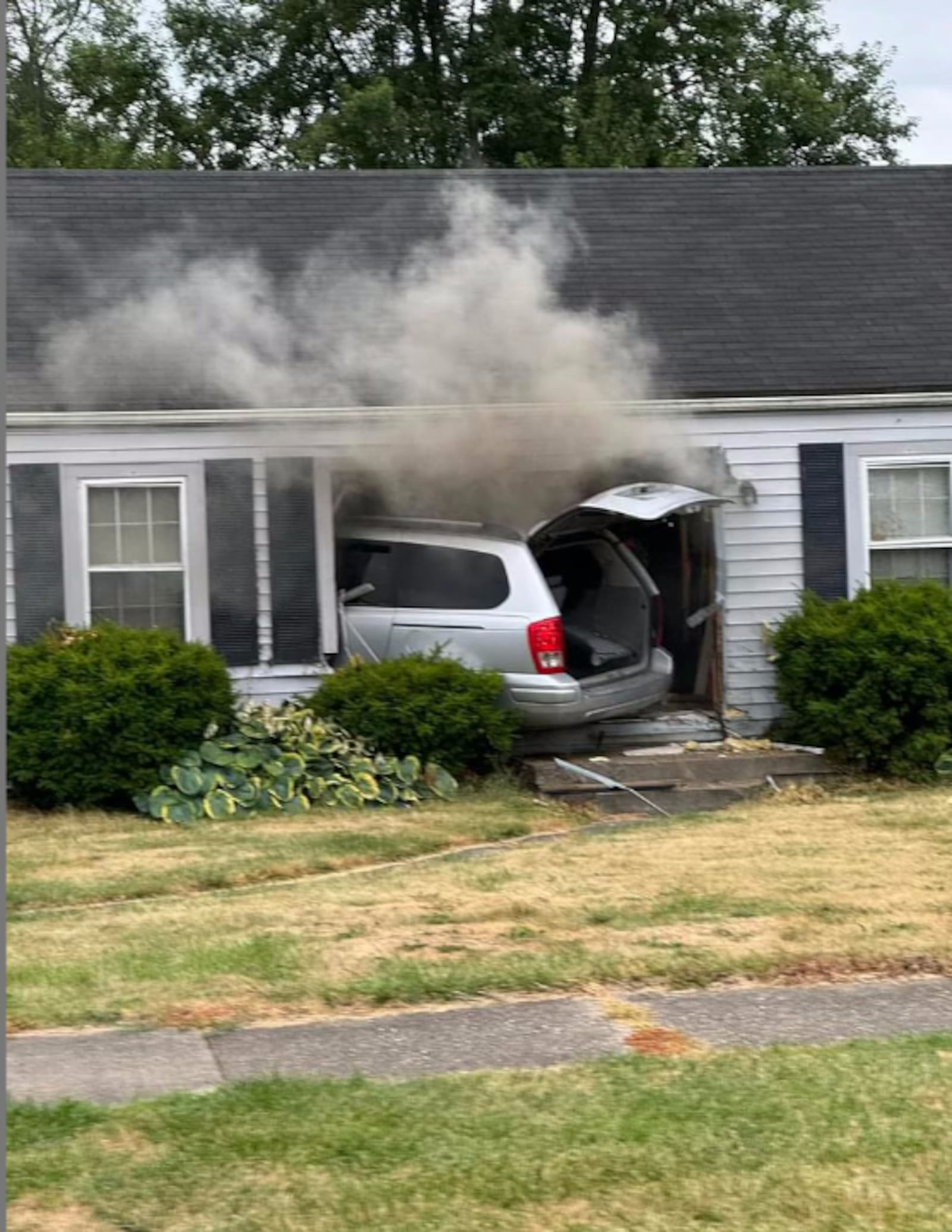 A minivan crashed into a Central Avenue house and then caught fire Wednesday evening, June 26, 2024, in Middletown. CONTRIBUTED