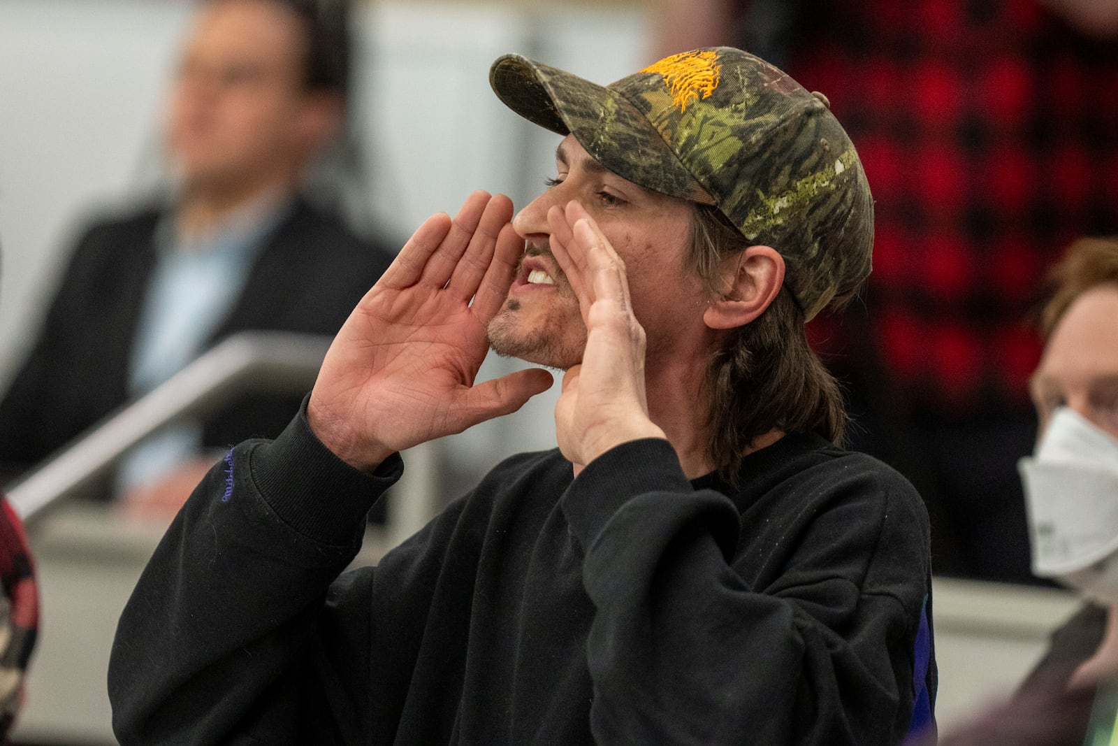 Owen Brings shouts a question to Reps. Celeste Maloy and Mike Kennedy, R-Utah, during a GOP town hall meeting Thursday, March 20, 2025, in Salt Lake City. (AP Photo/Rick Egan)