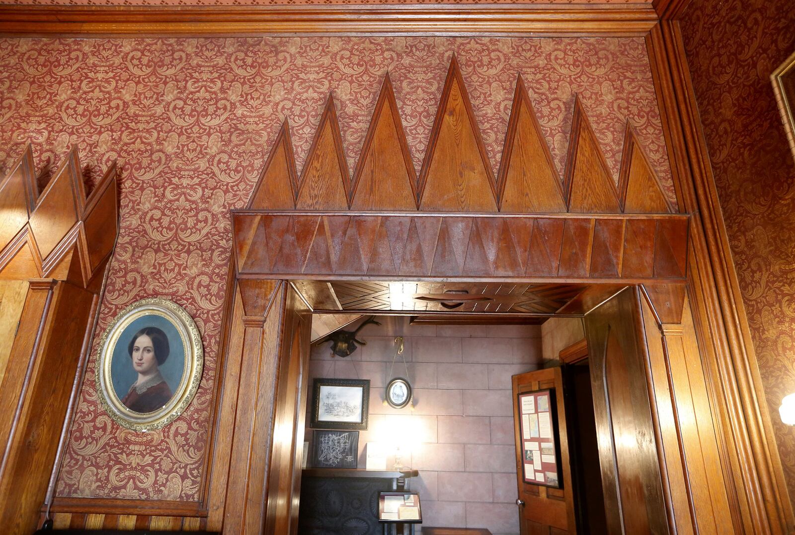 A combination of rich styling and odd design decorate the rooms at Mac-A-Cheek. In the library, where wine colored fabric covers the walls, quirky wooden points have been cut around the door frames. LISA POWELL / STAFF