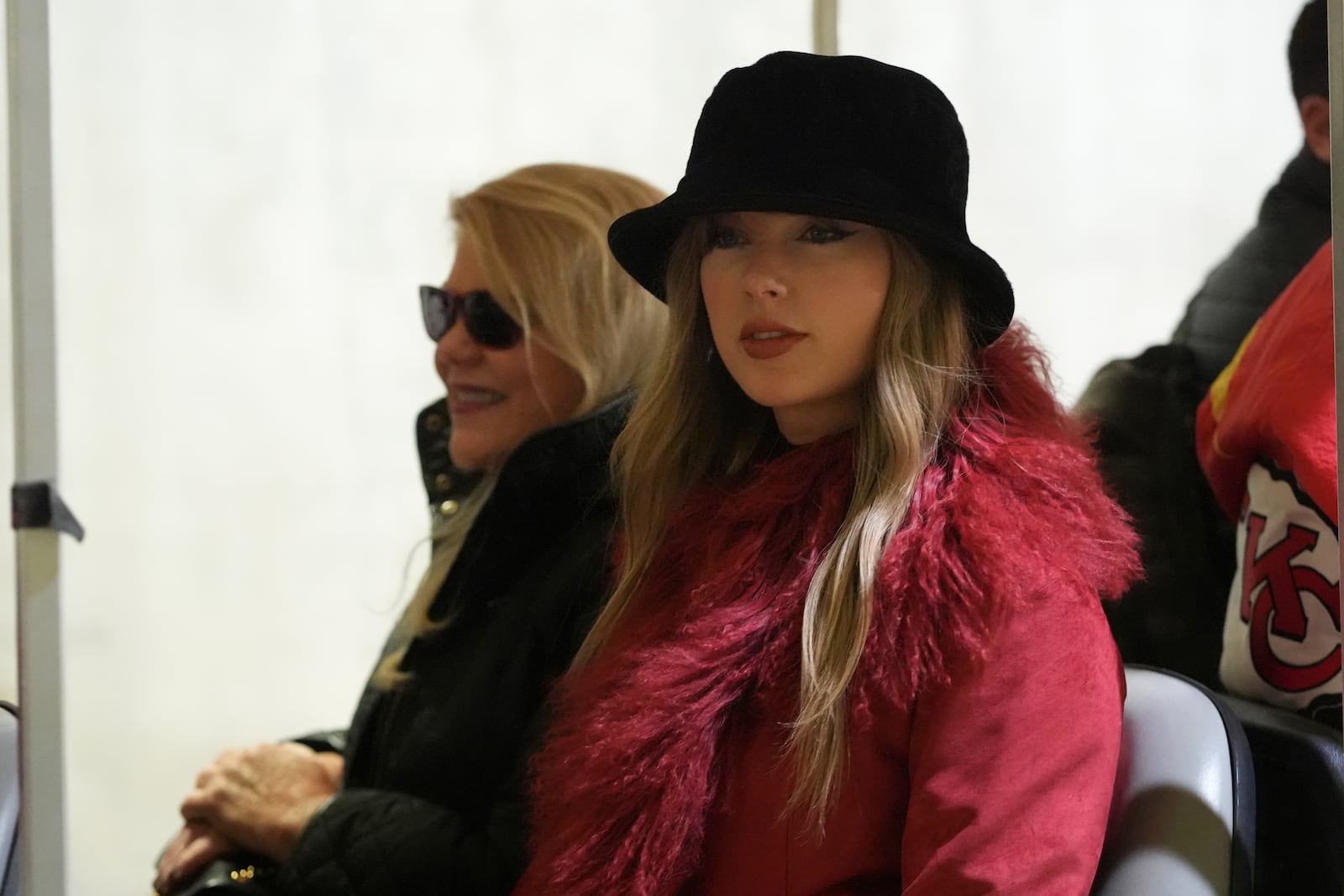 Taylor Swift arrives with her mother Andrea Swift, left, before an NFL football game between the Kansas City Chiefs and the Houston Texans Saturday, Dec. 21, 2024, in Kansas City, Mo. (AP Photo/Charlie Riedel)