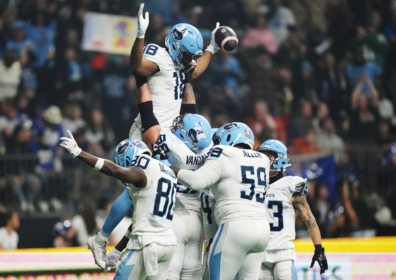 Toronto Argonauts' Dejon Brissett (18) celebrates his touchdown against the Winnipeg Blue Bombers with teammates during the second half of a CFL football game at the 111th Grey Cup in Vancouver, British Columbia, Sunday, Nov. 17, 2024. (Nathan Denette/The Canadian Press via AP)