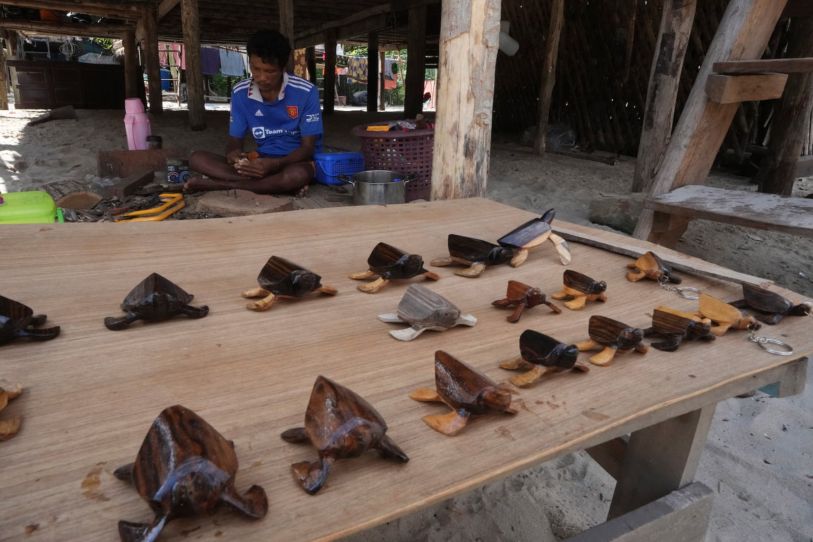 Pek Klathale makes handicraft for tourists to buy in Moken village at Surin Islands in Phang Nga Province, Thailand, Wednesday, Dec. 11, 2024. (AP Photo/Sakchai Lalit)