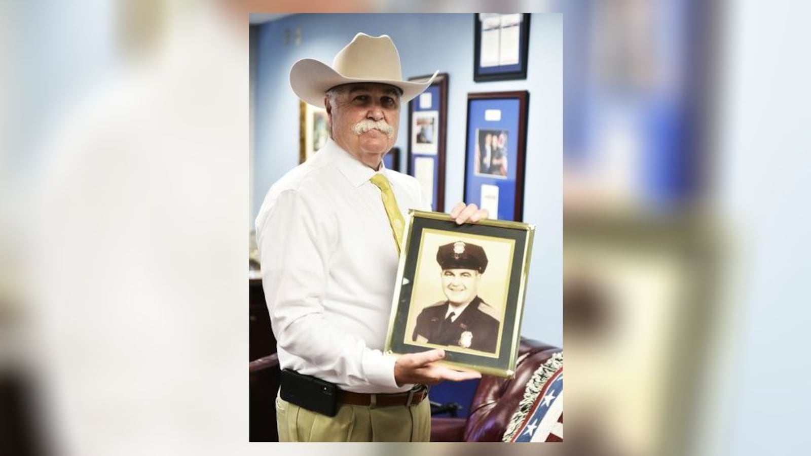 Butler County Sheriff Richard Jones holds a photo of his father, Dillard, who was a Hamilton police officer and fought in World War II at the Battle of the Bulge. NICK GRAHAM/STAFF