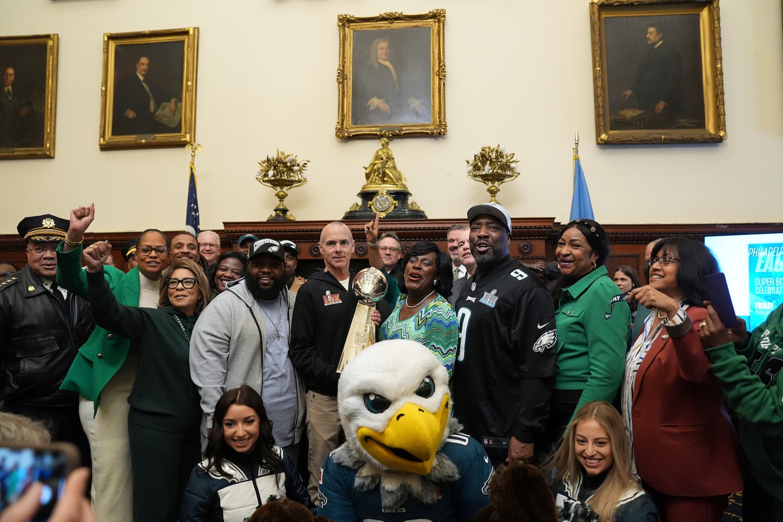 Philadelphia Mayor Cherelle Parker, accompanied by Philadelphia Eagles President, Don Smolenski, and other officials poses for photographs during a news conference in Philadelphia, Tuesday, Feb. 11, 2025, ahead of a planned Philadelphia Eagles NFL Super Bowl 59 football victory celebration. (AP Photo/Matt Rourke)